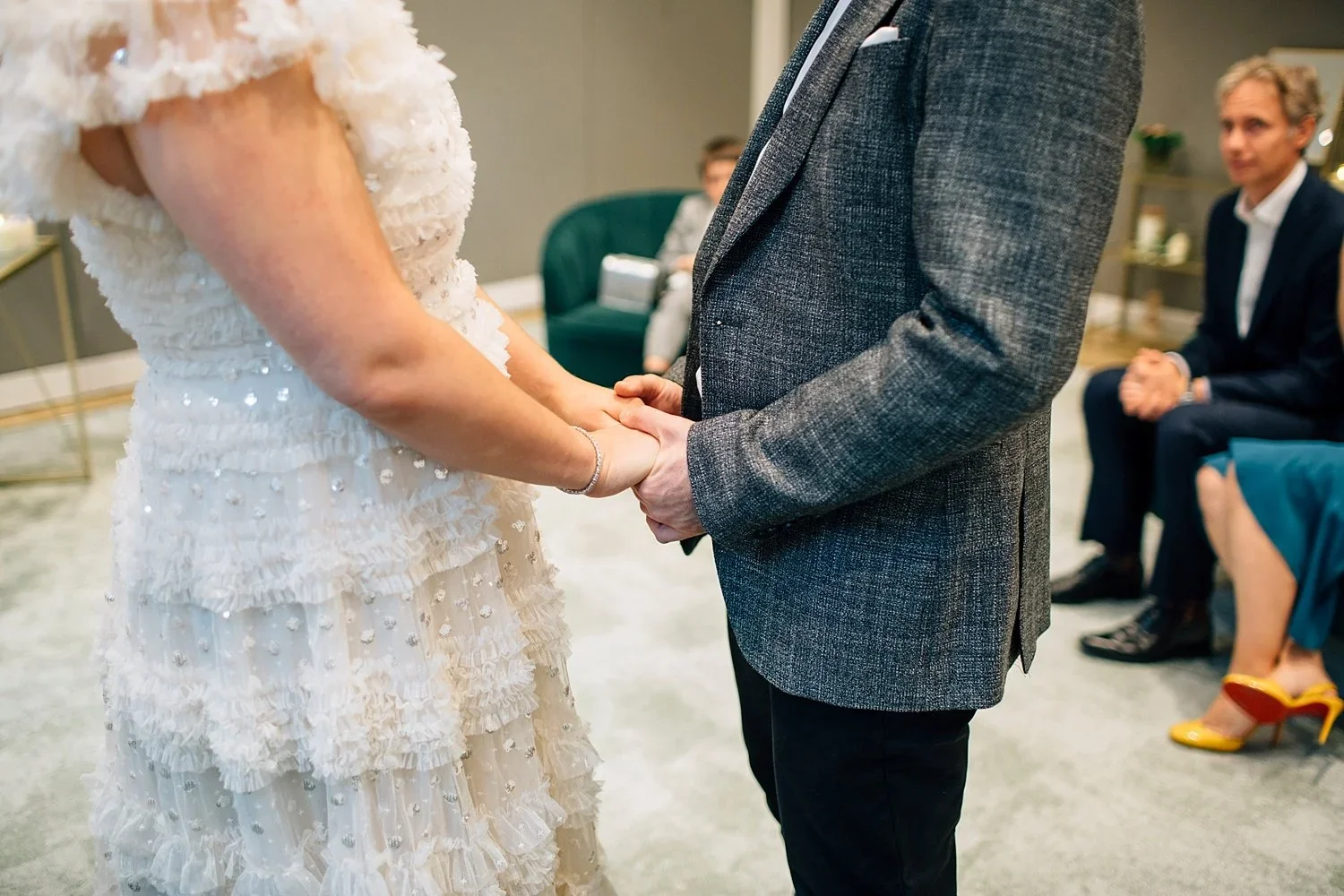 French couple holding hands during their intimate Camden Town Hall wedding ceremony