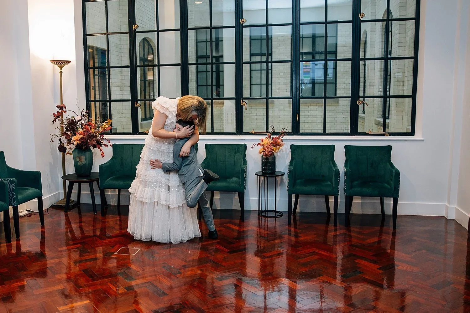Bride hugging her child during their Camden Town Hall wedding