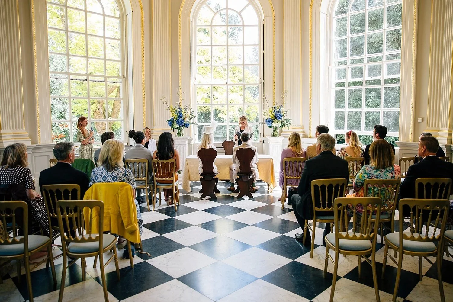 Guests seated for a wedding ceremony in the Octagon Room at Orleans House Gallery