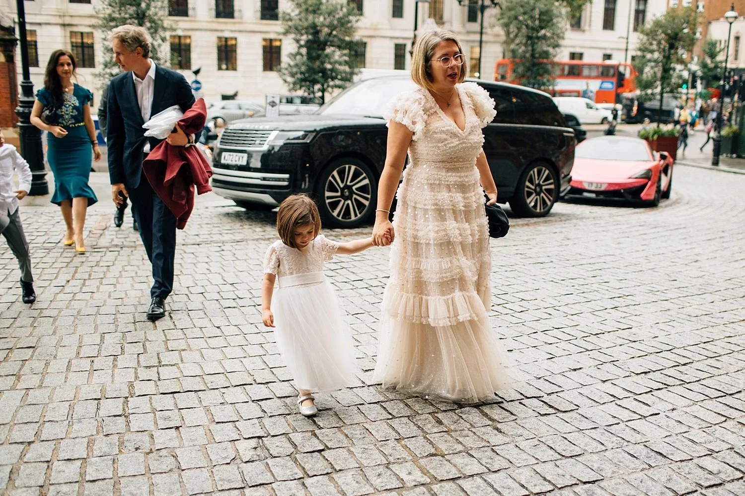 Bride and daughter walking through London after their Camden Town Hall wedding