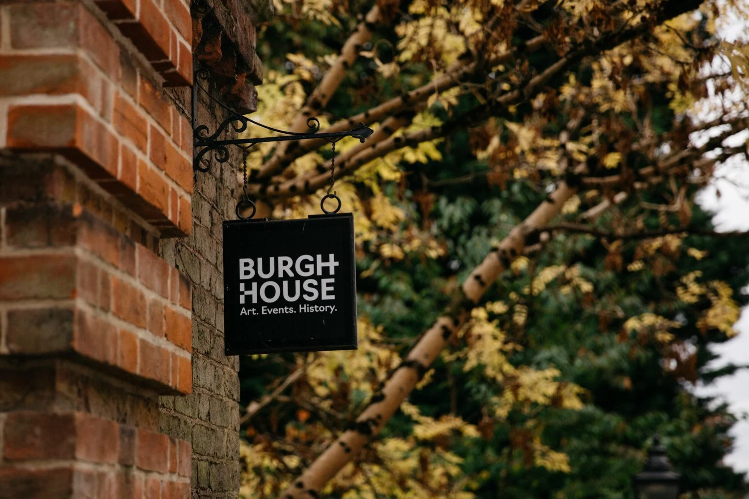 Burgh House sign surrounded by autumn leaves in Hampstead, London