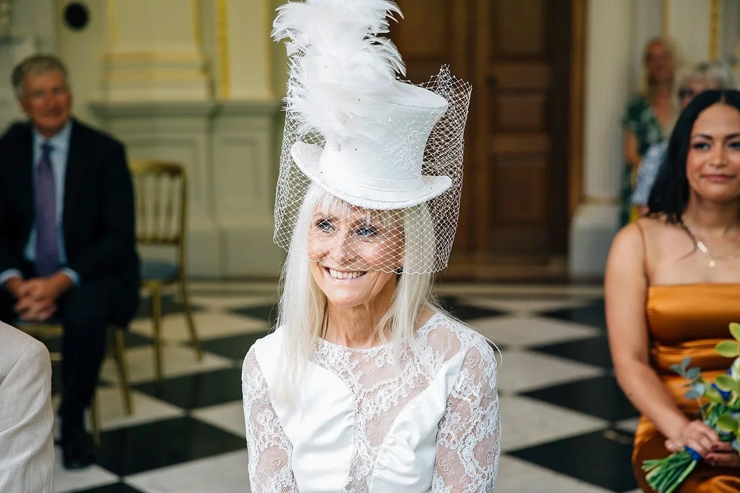 Bride wearing a white top hat during her Orleans House Gallery wedding ceremony
