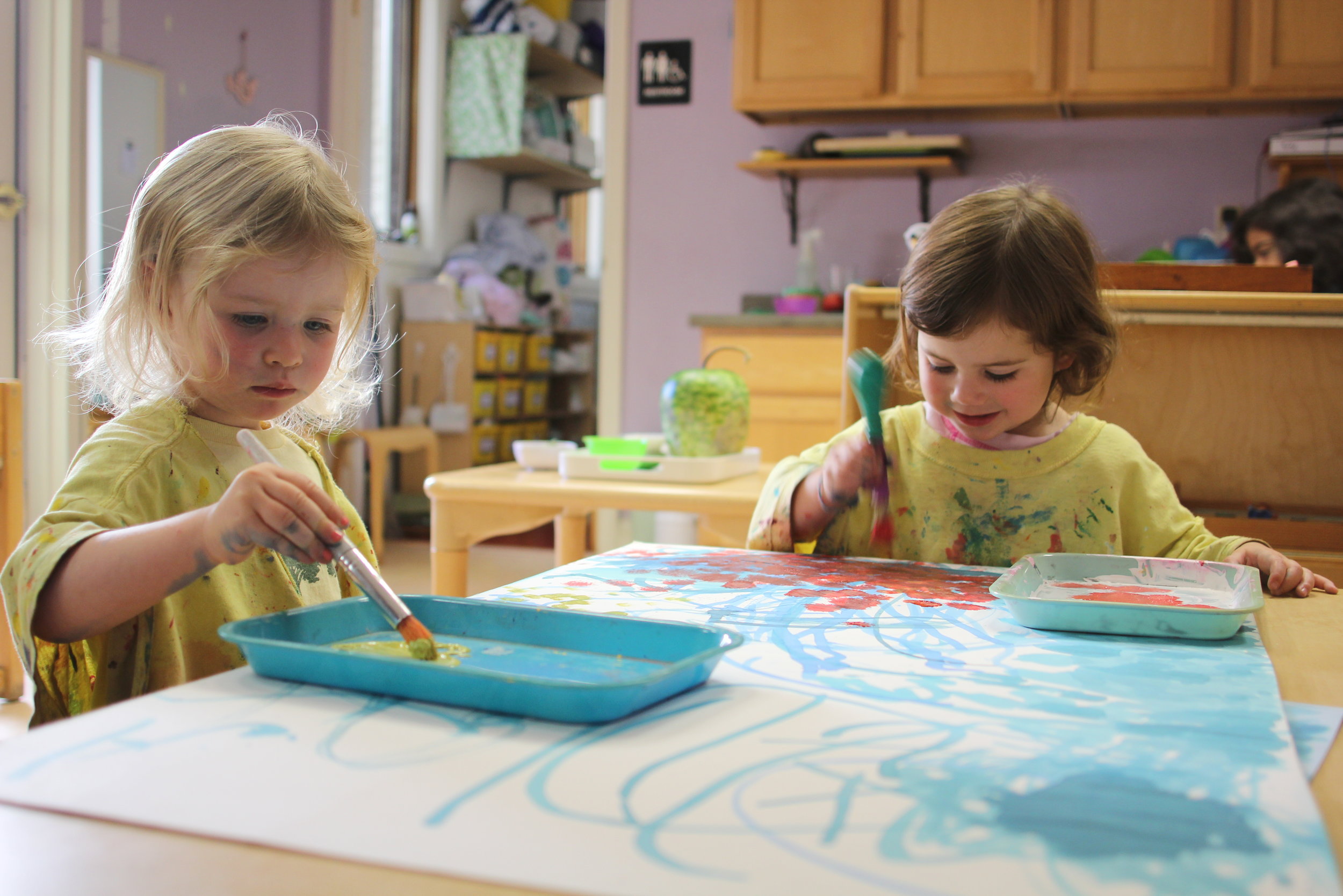  These two toddlers paint a fall sky. 