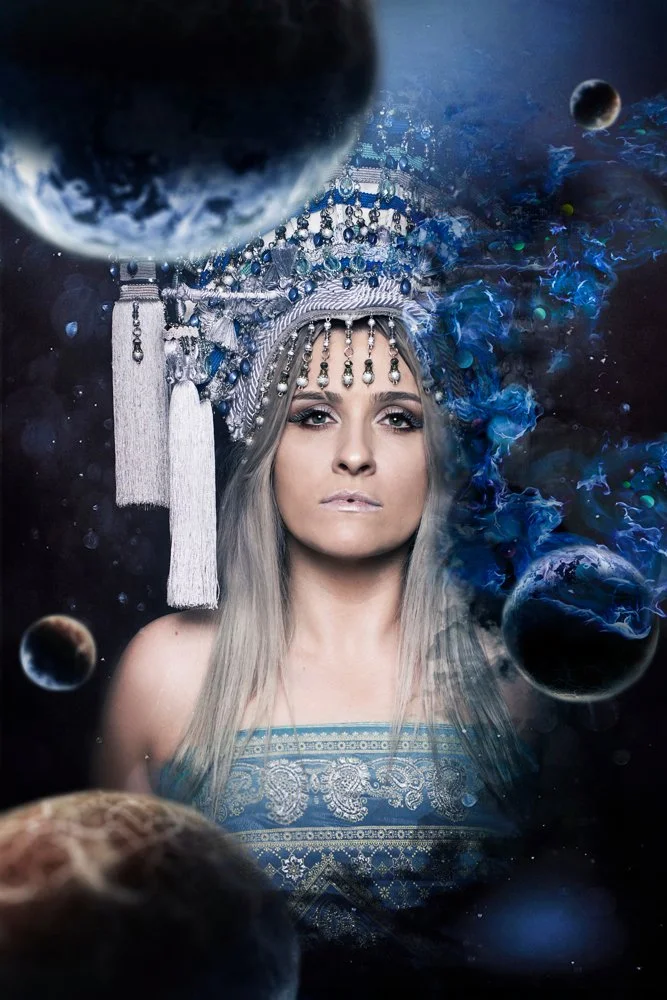 A fantasy portrait with a blue headdress and celestial imagery