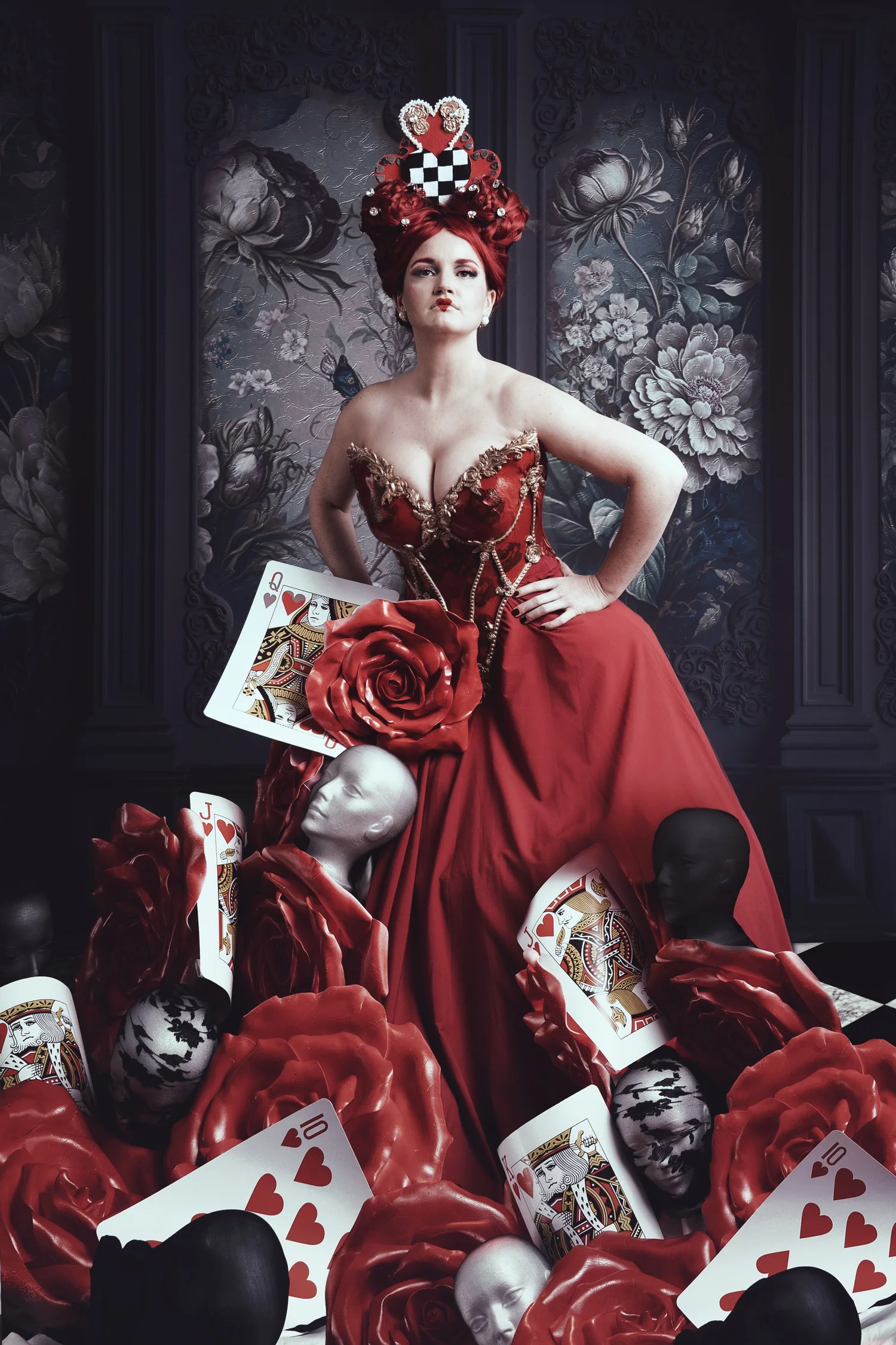 Fine art portrait with a red gown, ornate headdress and theatrical setting