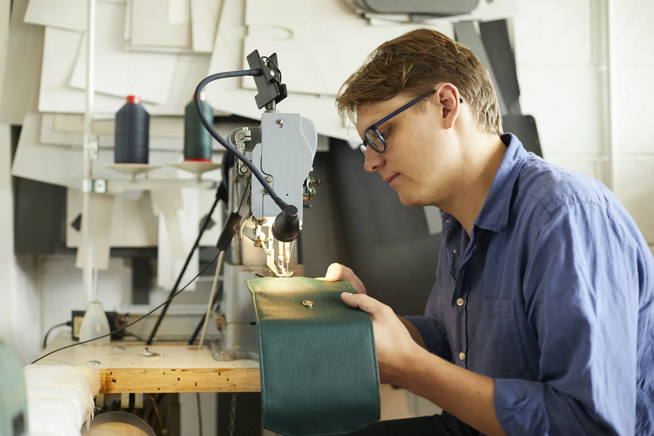Charlie making the jewellery roll using traditional techniques.