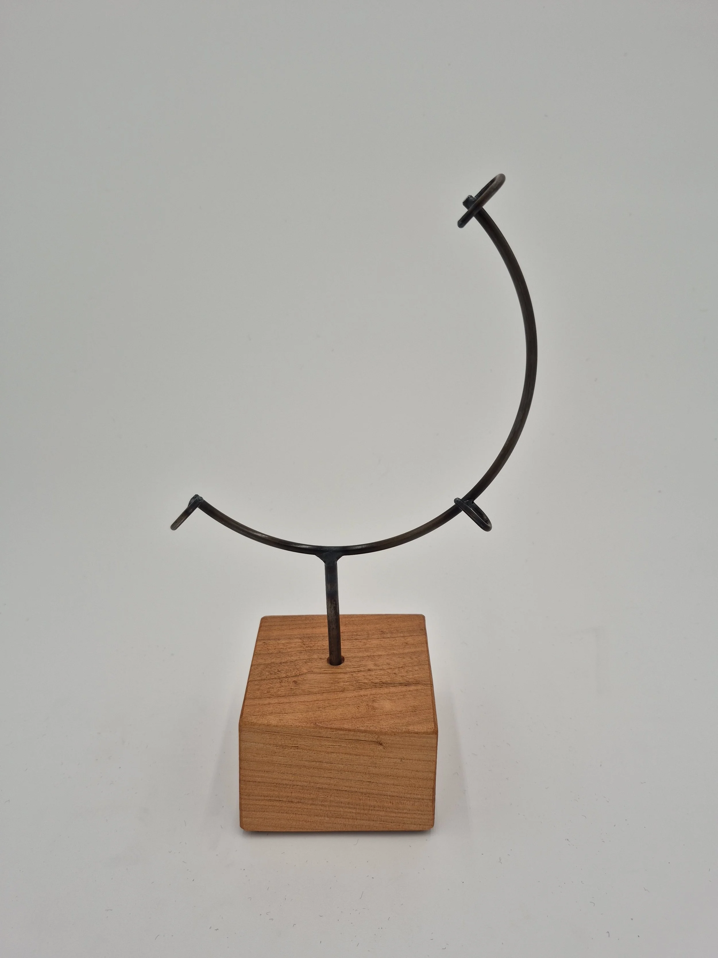 8" round glass display stand on cherry