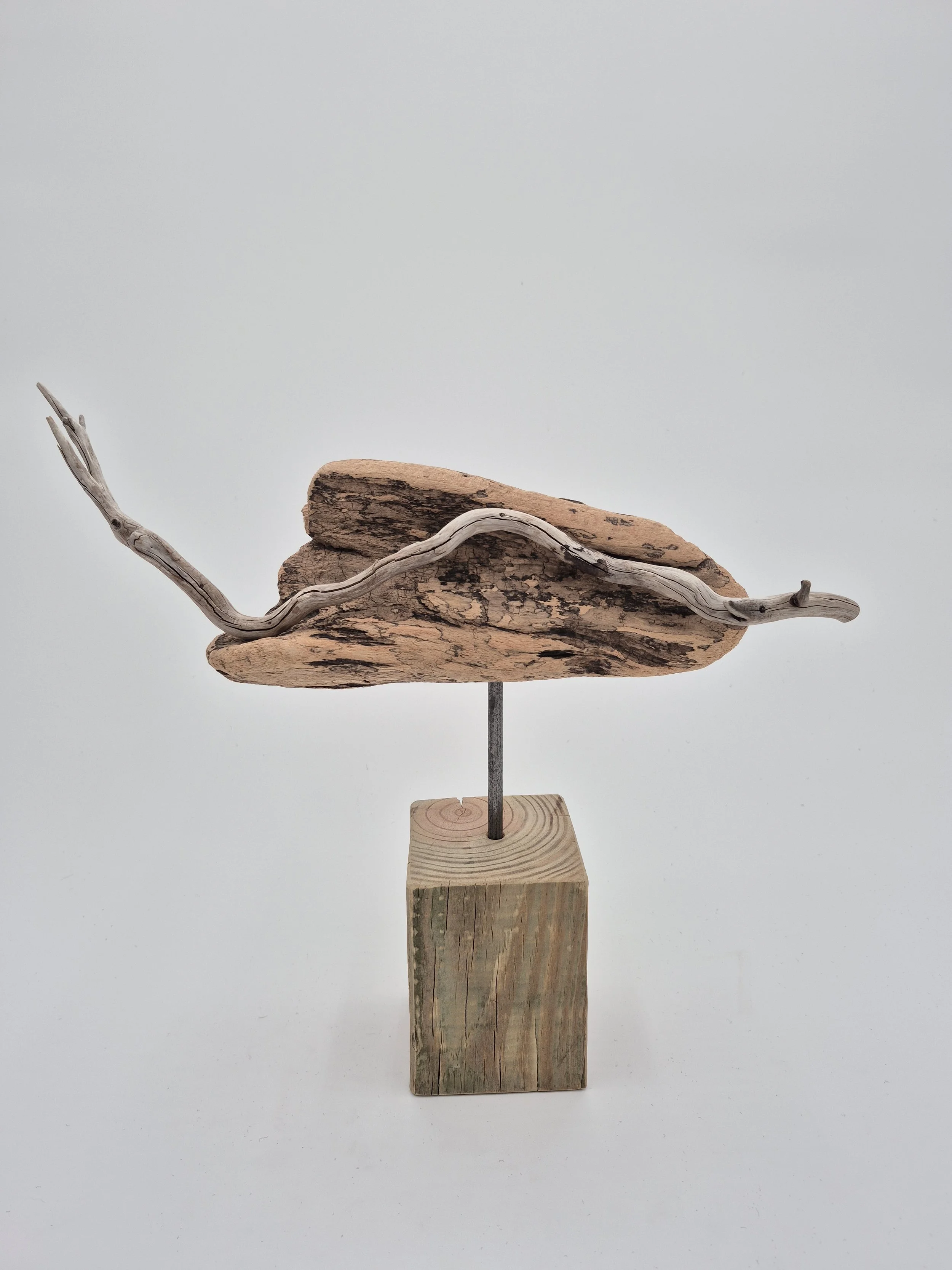 driftwood sculpture on weathered block