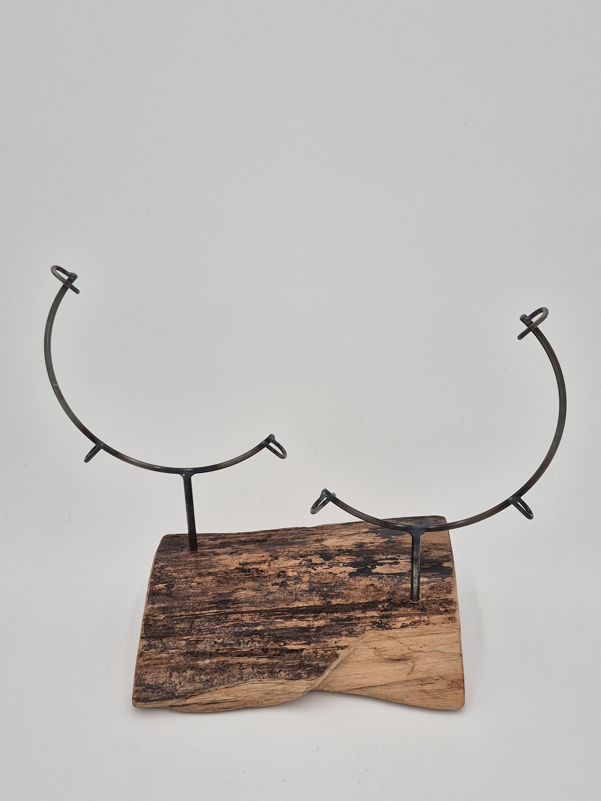 two 8" glass stands on black walnut