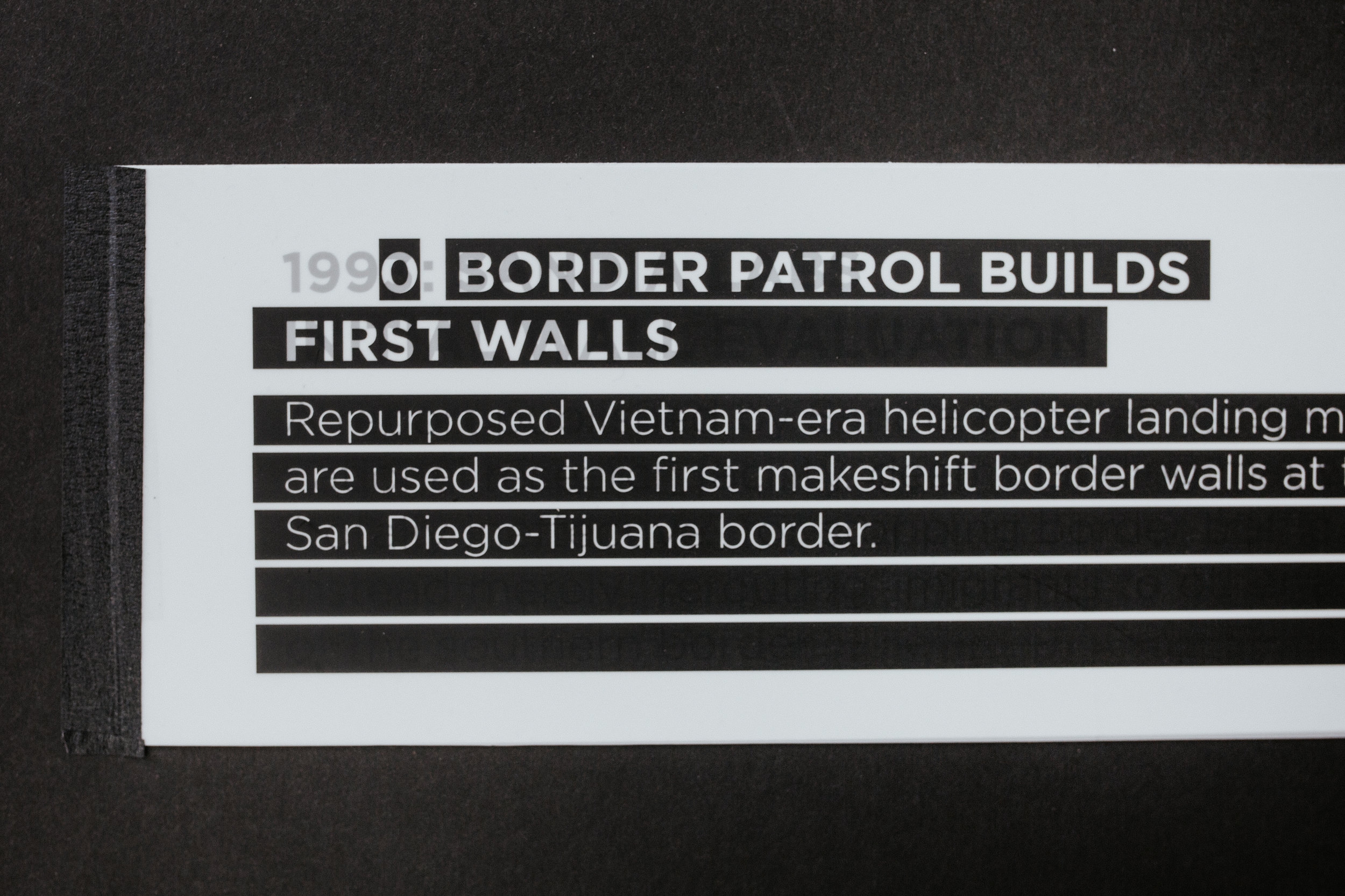 Thus I designed my installation to present the juxtaposing, hypocritical history of border legislation in a series of interactive wall panels. As I found the legislation to effectively hide or discount the juxtaposing studies and actual statistics at the border, I chose to display that legislation information on top so that the underlying study appears “redacted” from history.