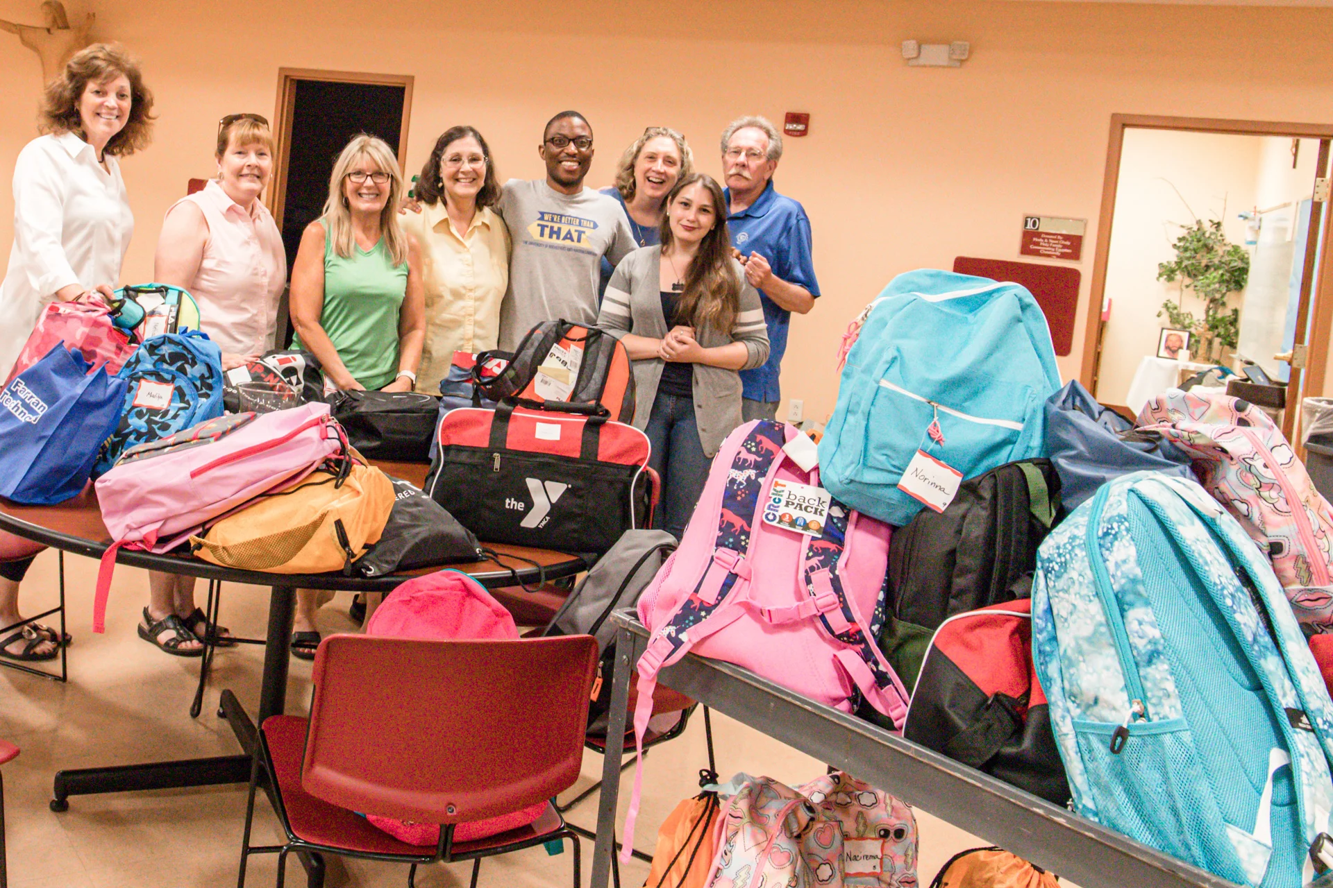 Volunteers from McC with the overwhelming donation of backpacks and school supplies.