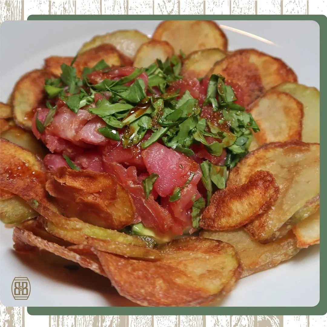 This is not your average appetizer 👀 At Barrel and Brew, our Ahi Tuna Avocado Stack drizzled with ginger soy and served with homemade chips is a show-stopper.