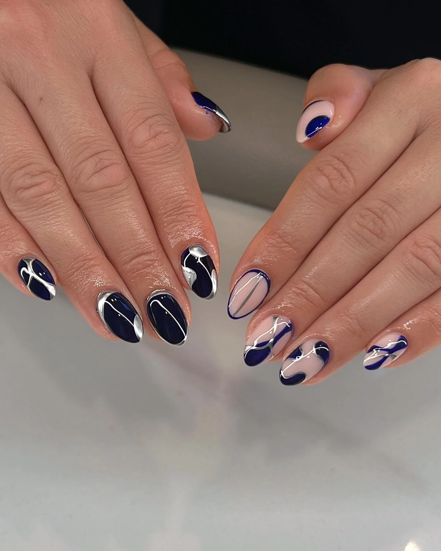 ✨ Bold. Chic. Unforgettable. ✨
Annie turned everyday nails into a modern art statement with this navy + nude abstract set. The deep midnight tones paired with sleek silver accents and soft nude balance create a perfect mix of edgy and elegant.

💅 Pe