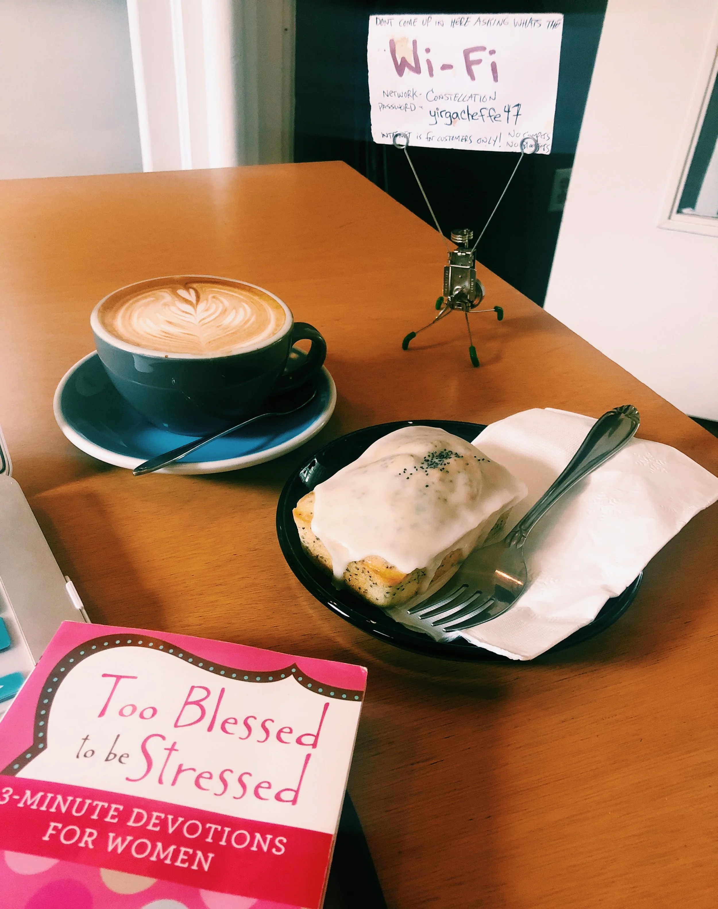 Cappuccino, lemon / poppy seed pastry and my Too Blessed to be Stressed daily prayer book at Constellation Coffee.