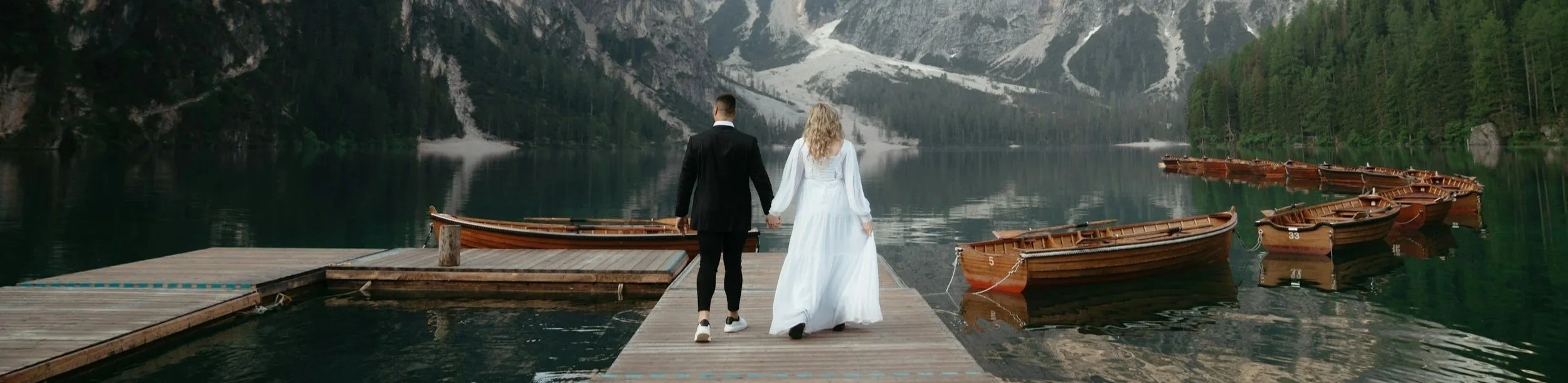 man and woman looking out over a lake getting maried