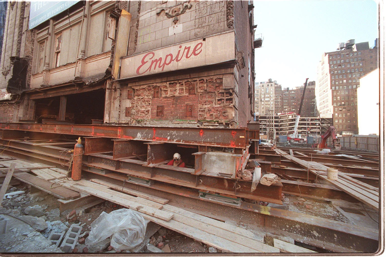 Construction workers putting the Empire Theatre on lifts for its move west. Credit: The New York Times