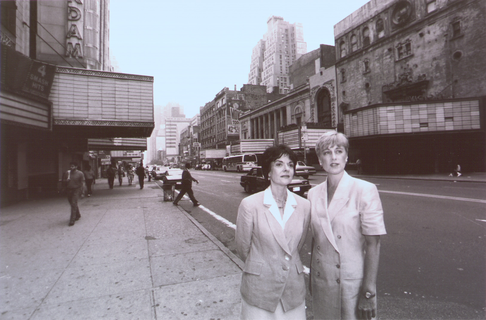 Rebecca Robertson (right) and Cora Cahan (left) stand with the empty theatres and stores of 42nd Street in the background. Credit: New York Times