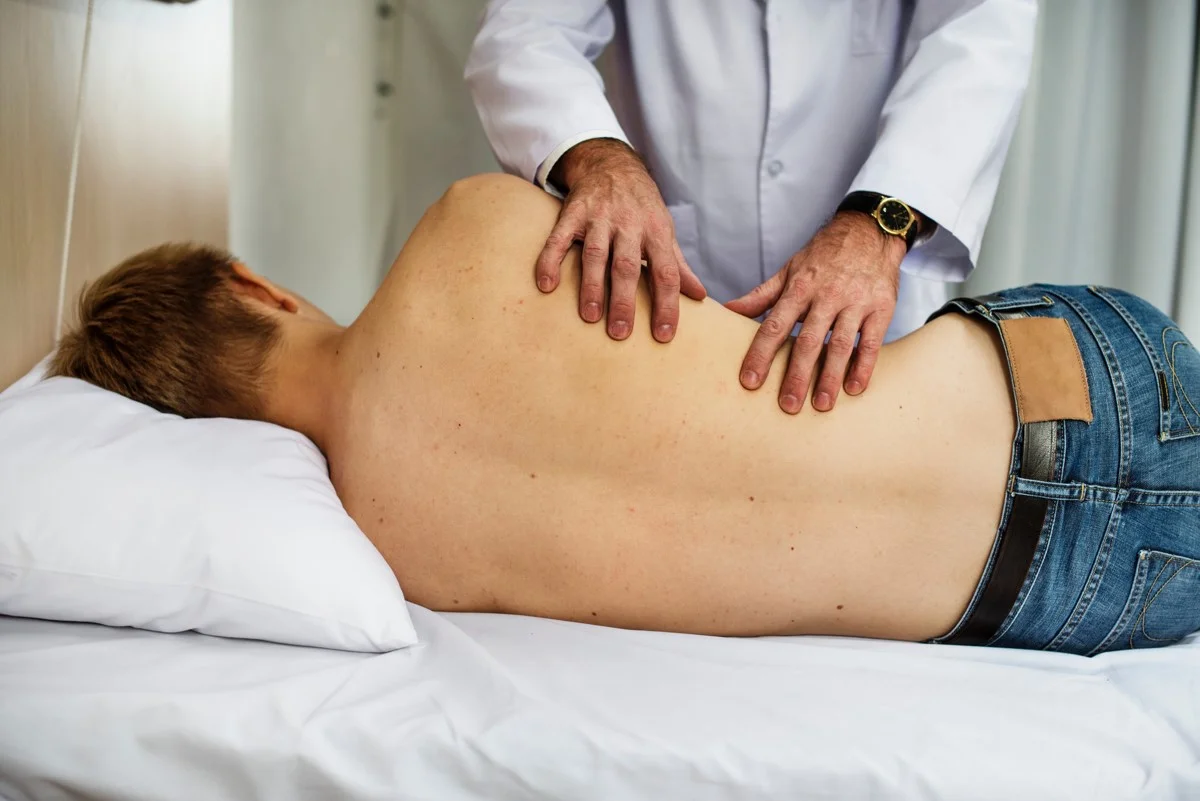 doctor examining patient back.jpg