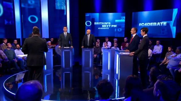 Conservative Party leadership hopefuls Jeremy Hunt, Sajid David, Michael Gove, Dominic Raab and Rory Stewart all took part in last nights channel 4 hustings, all bar one, front runner and leadership contender Boris Johnson. In what can only be described as a good-tempered hustings amongst the Tory leadership hopefuls, there was no clear winner of the hustings, although that said, Rory Stewart emerged as the favourite amongst audience members. Questions varied from how do you intend to defeat Jeremy Corbyn and Nigel Farage to caring for elderly members of society to what is your top priority if you become prime minister. Michael Gove spoke passionately about the need to “prevent Jeremy Corbyn from getting into parliament” and that “the party needs someone who has strong beliefs in conservative principles” and further warned against the prospect of a Jeremy Corbyn government who he said “would push Marxist economics”. Throughout the hustings, Mr Gove spoke about his achievements in office and that he is often told something isn’t achievable and then proving sceptics wrong and further illustrated his point by talking about the leave campaign and winning. Jeremy Hunt was the first candidate to attack Boris Johnson in which he said “I just want to say: where is Boris? If his team won’t let him out to debate with five friendly colleagues, how is he going to get on with 27 European colleagues? He should be here to answer that question.” Throughout the hustings Jeremy spoke about being an entrepreneur and his ability to negotiate a deal and that he was the man to deliver Brexit, and subsequently this became a major theme of the hustings in which both Dominic Raab and Sajid David spoke about their respective backgrounds as a lawyer and banker and having been involved in multibillion dollar deals. Rory Stewart, the outside horse whose campaign is clearly gaining momentum received the biggest applause from the audience as a result of his straight talking no nonsense and yet humorous approach to questions from the audience. Mr Stewart said “the fundamental issue here is that there is a competition of machismo. Everyone is saying I’m tougher. Every time I have this debate everyone is like, trust me I’m the guy, I can defeat the impossible odds. And I’m accused of being a defeatist by trying to be realistic. It reminds me of trying to cram a whole series of rubbish bags into the rubbish bin, I was tempted to say believe in the bin, believe in Britain, its rubbish.” In distancing himself from the other contenders, Mr Stewart said “all four other candidates, Jeremy Hunt, Dominic Raab, Michael Gove and Sajid David, are willing to contemplate a no deal Brexit as an option, but a no deal Brexit is nonsense. It’s going to deeply damage our economy.” They say a week is a long time in politics, but the next 24 hours is going to be make or break for the remaining leadership hopefuls.