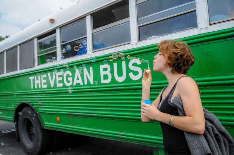 Alisa Kowal blows bubbles by the Vegan Bus