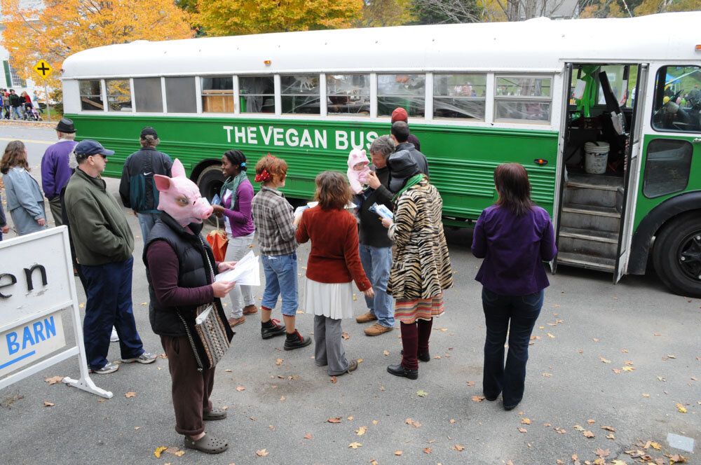 A crowd of festival goers around the Vegan Bus