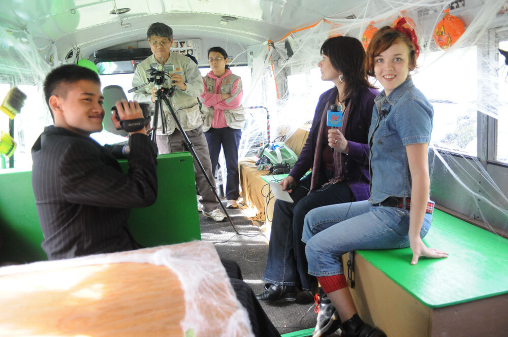 The Vegan Bus crew being filmed by the Supreme Master crew