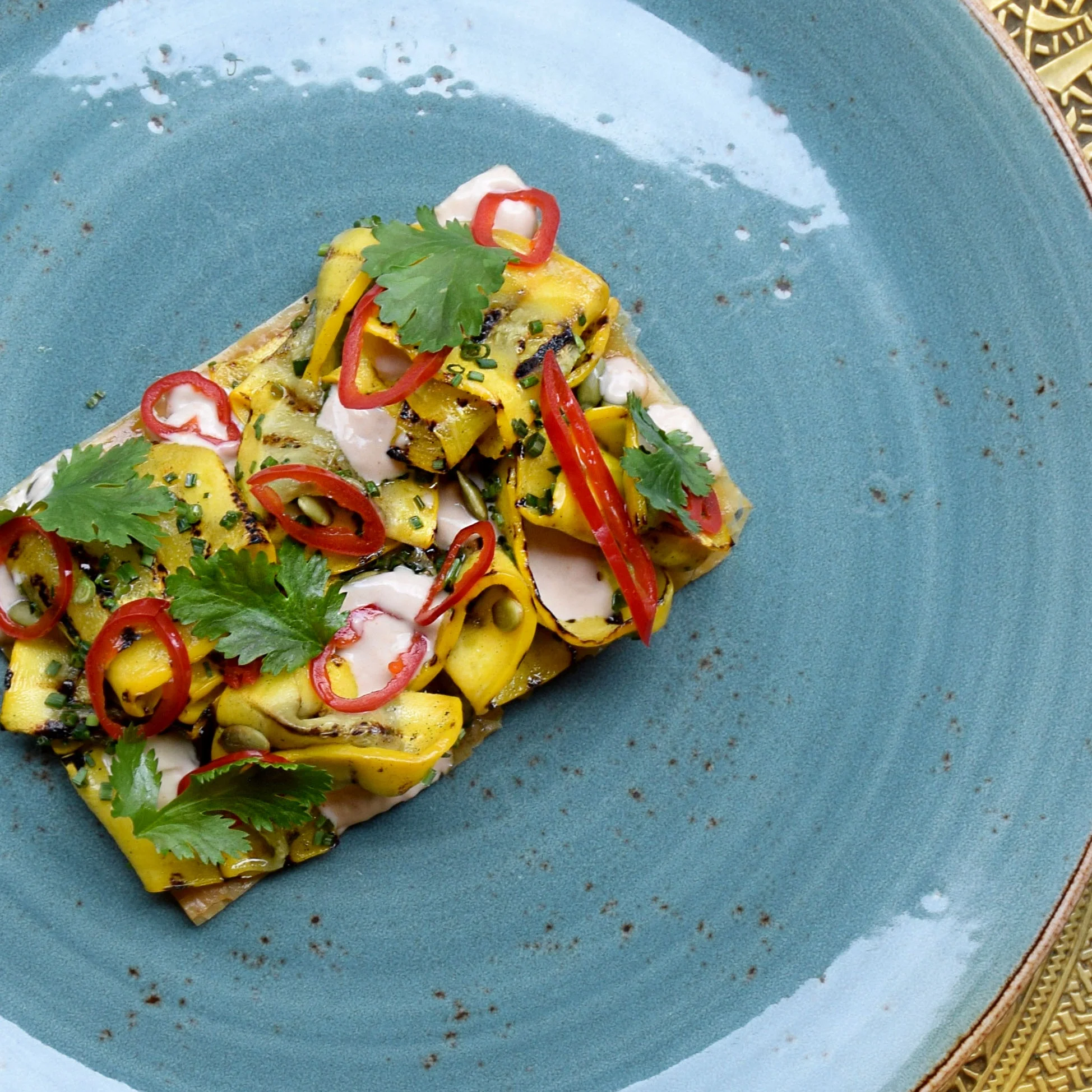 Vegan Grilled aubergine tartlet, coconut labneh, pickled chillies