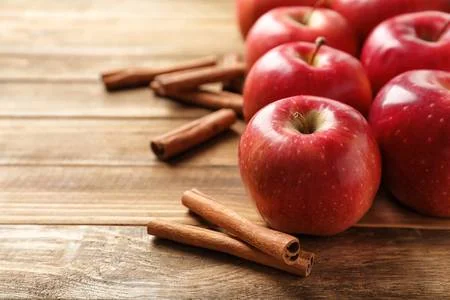 105450528-fresh-apples-and-cinnamon-sticks-on-wooden-table.jpg