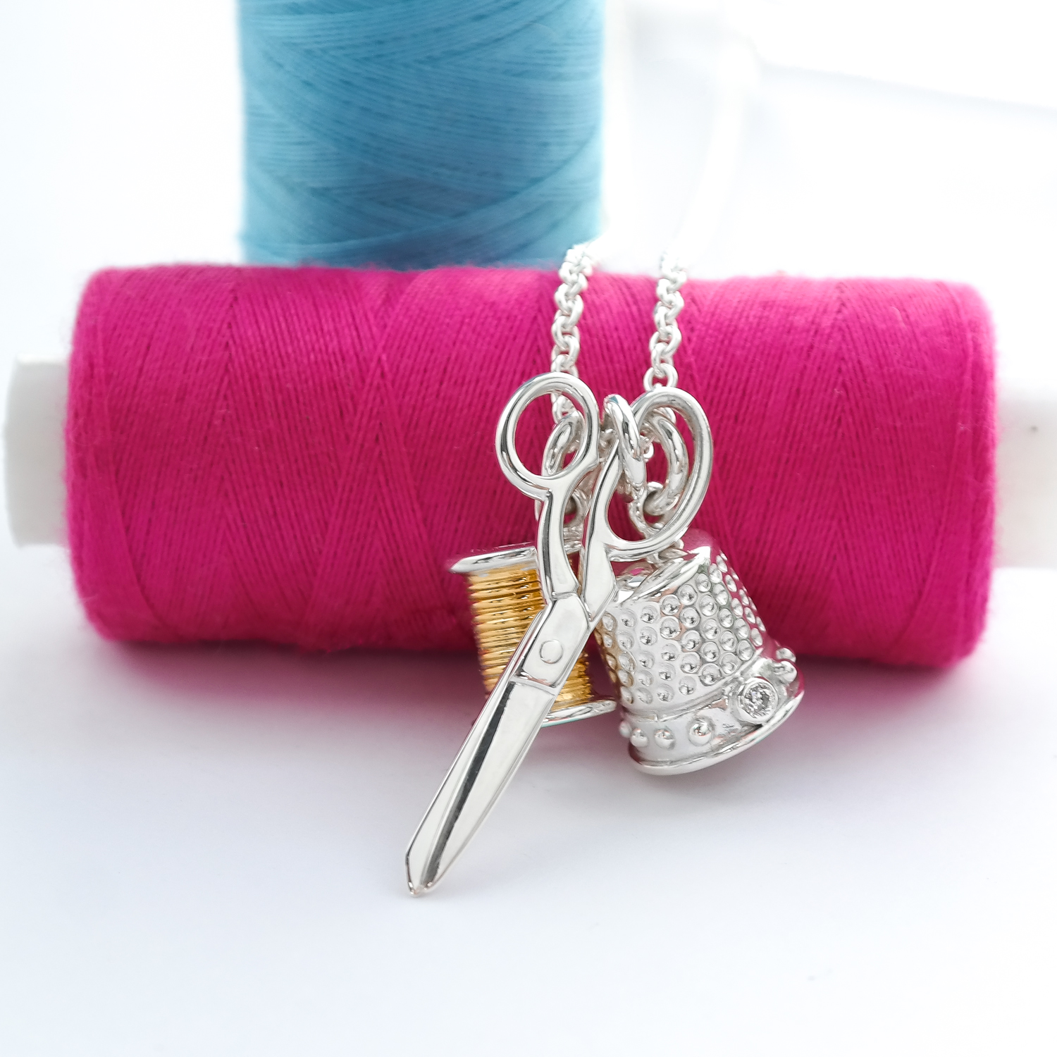 Silver sewing charm necklace with thimble scissors and cotton 