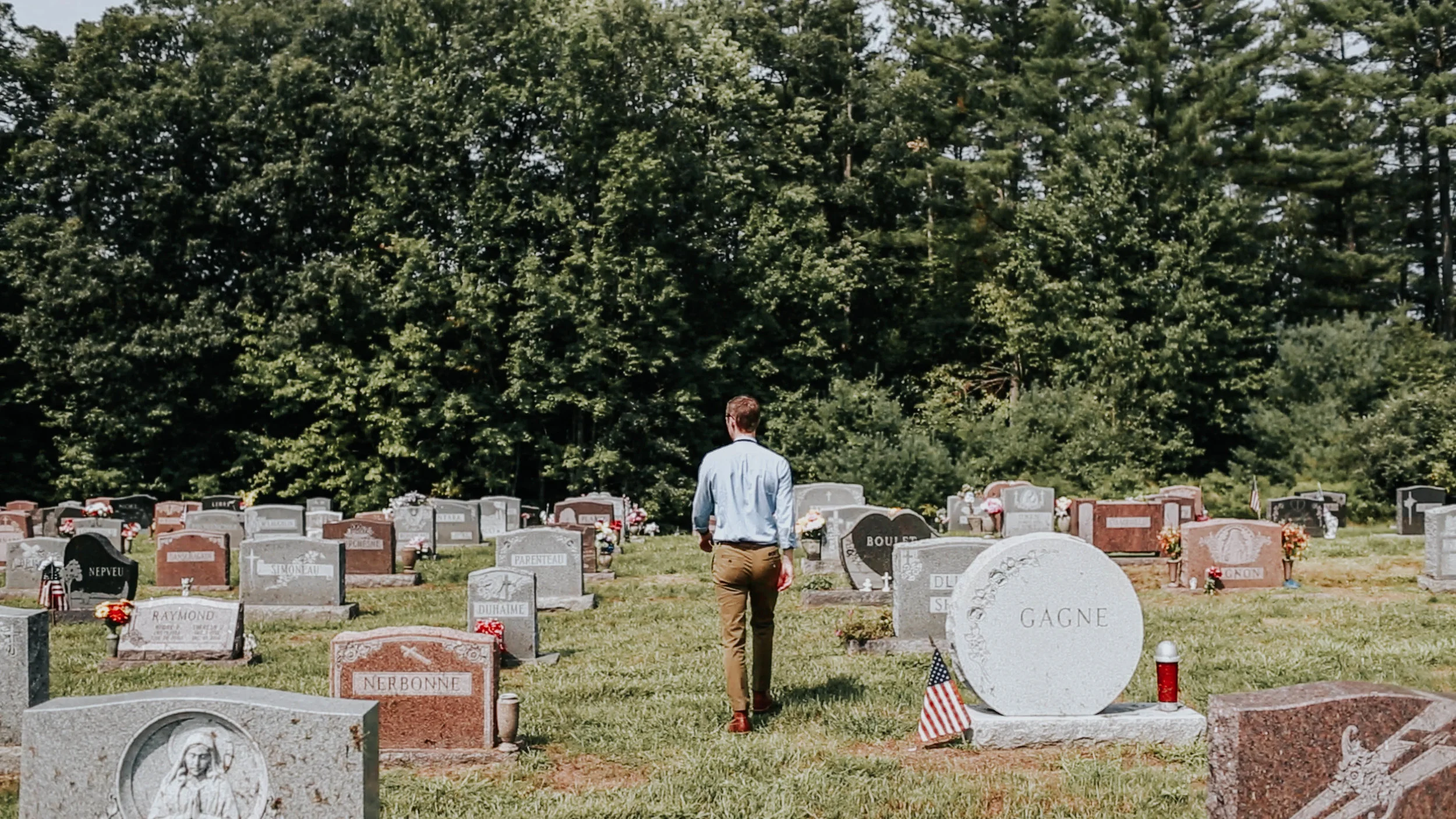 Jason Moon walks through the Saint John Baptiste cemetery.