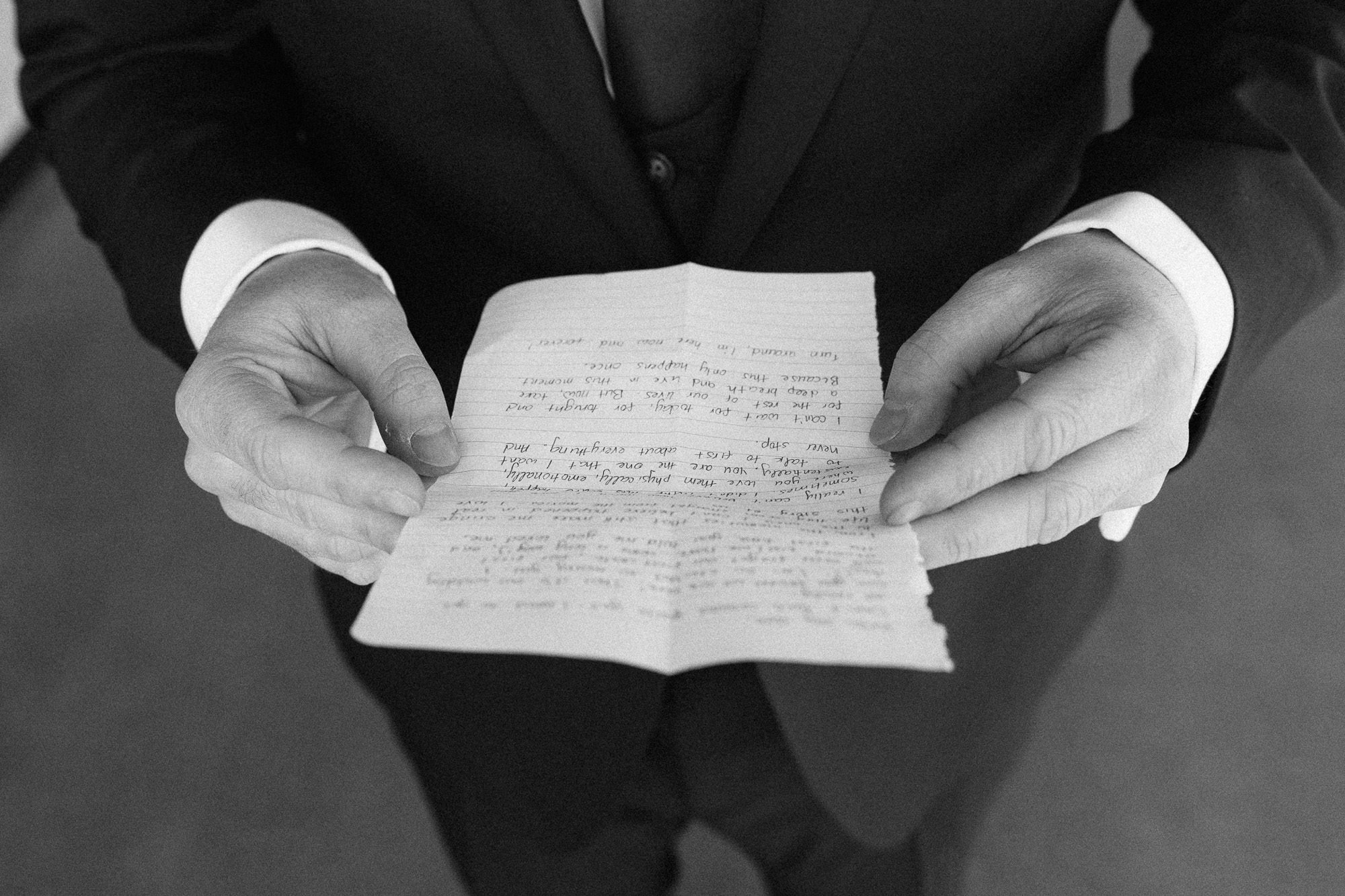 mans hands hold a handwritten note