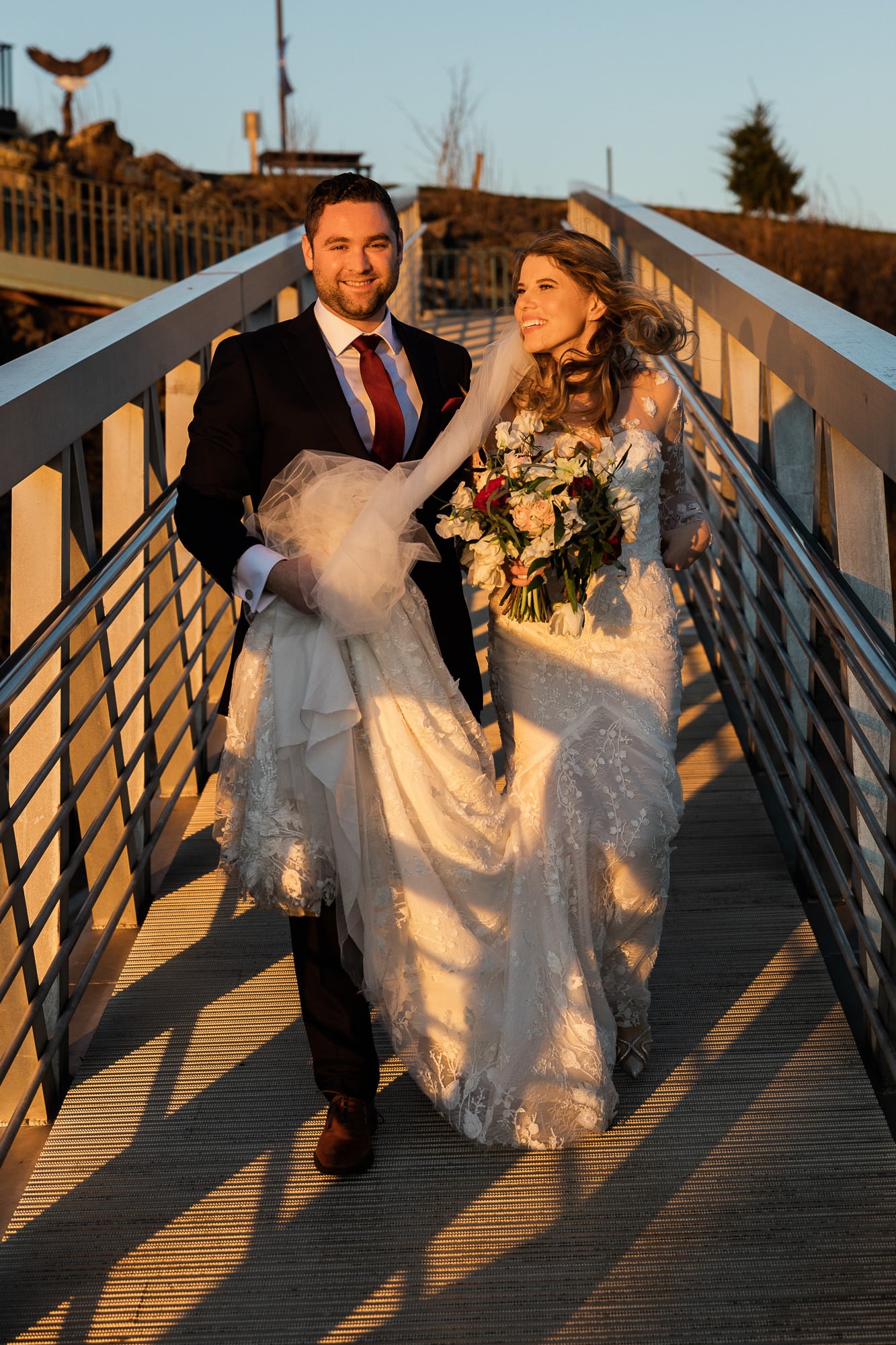 bride and groom walk down boat dock on columbia river in portland, oregon