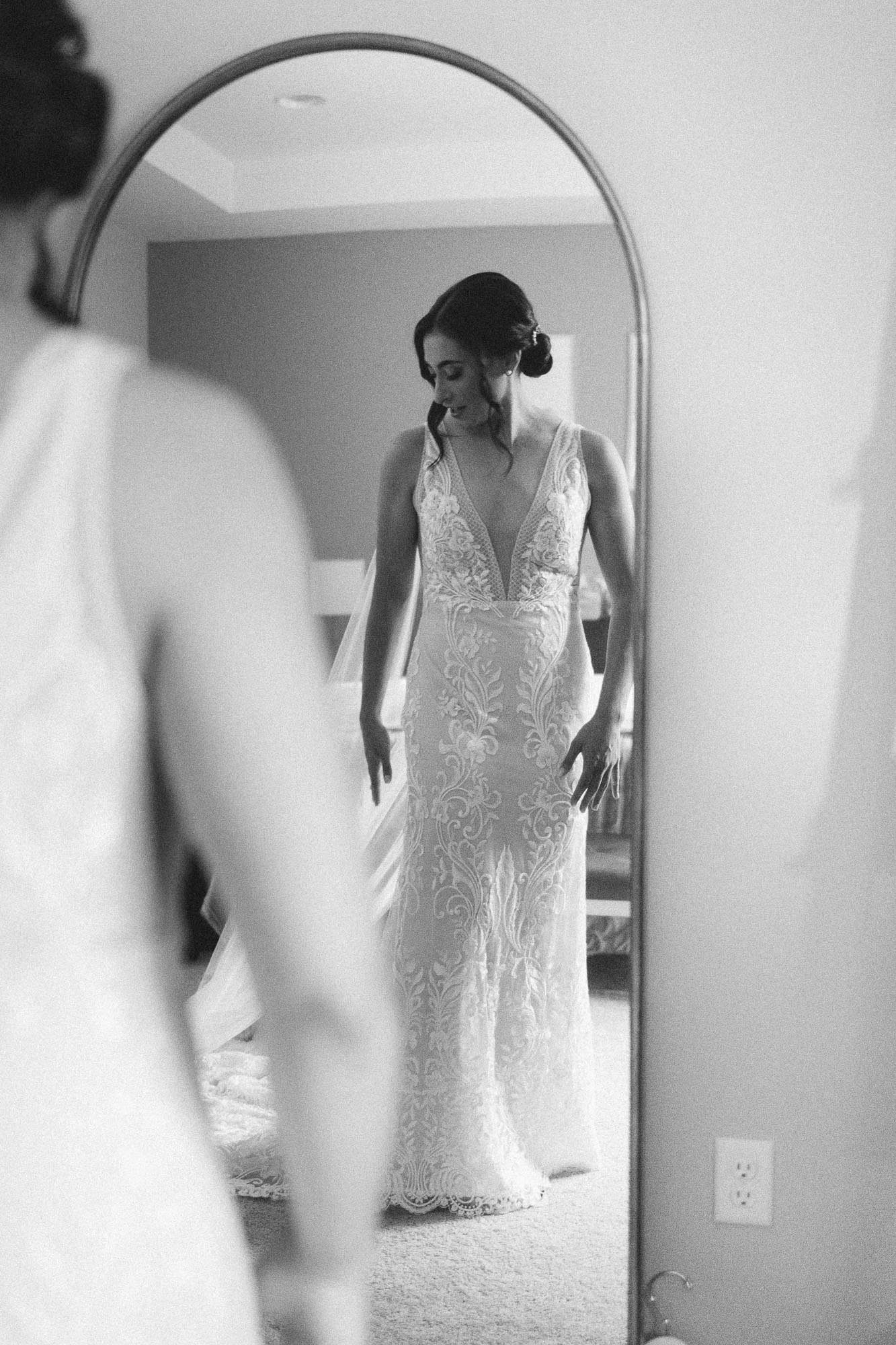 bride wearing lace A&amp;BÉ bridal shop dress looks in full length mirror