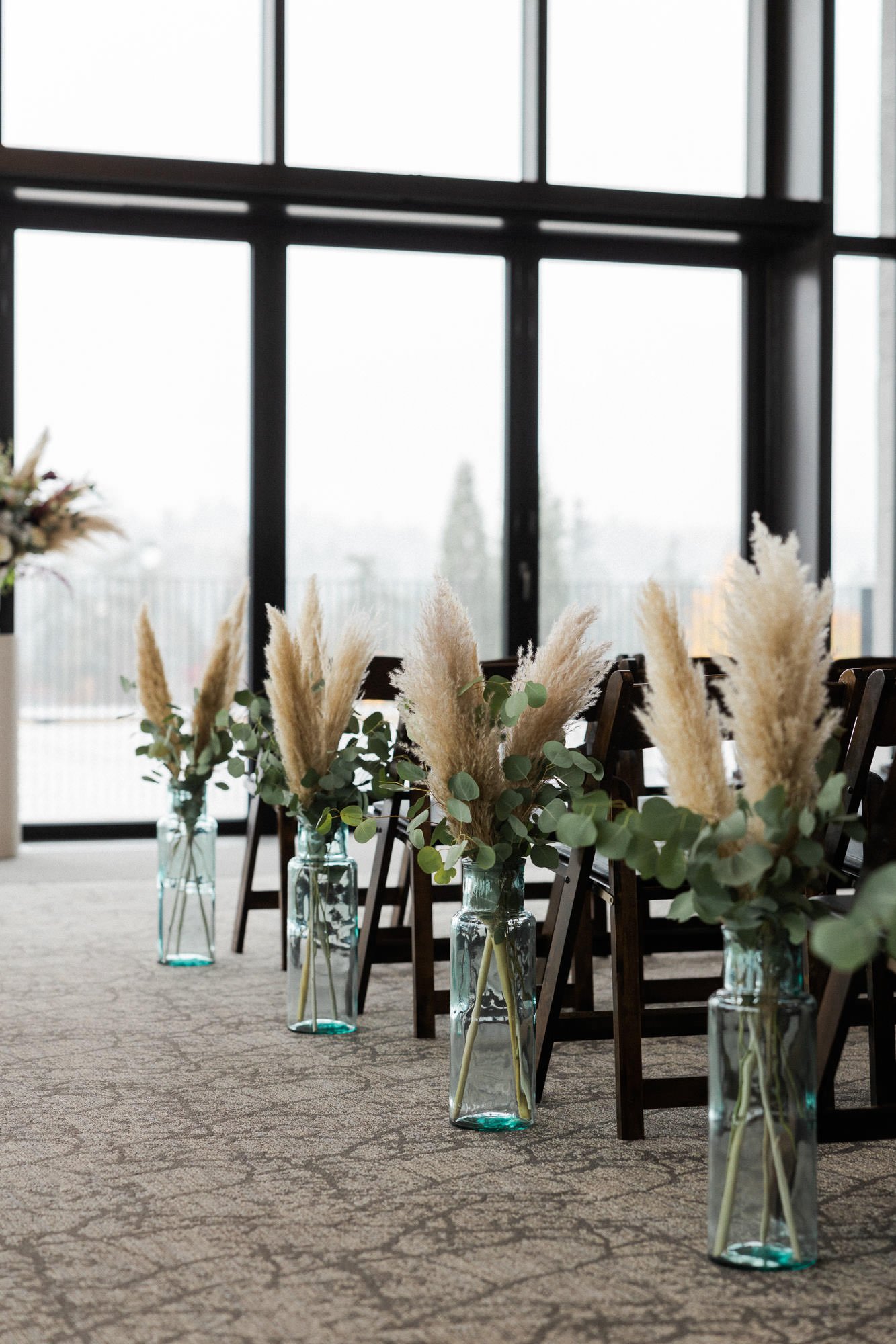 pampas grass in vases lining aisle at ironlight wedding venue in lake oswego, oregon