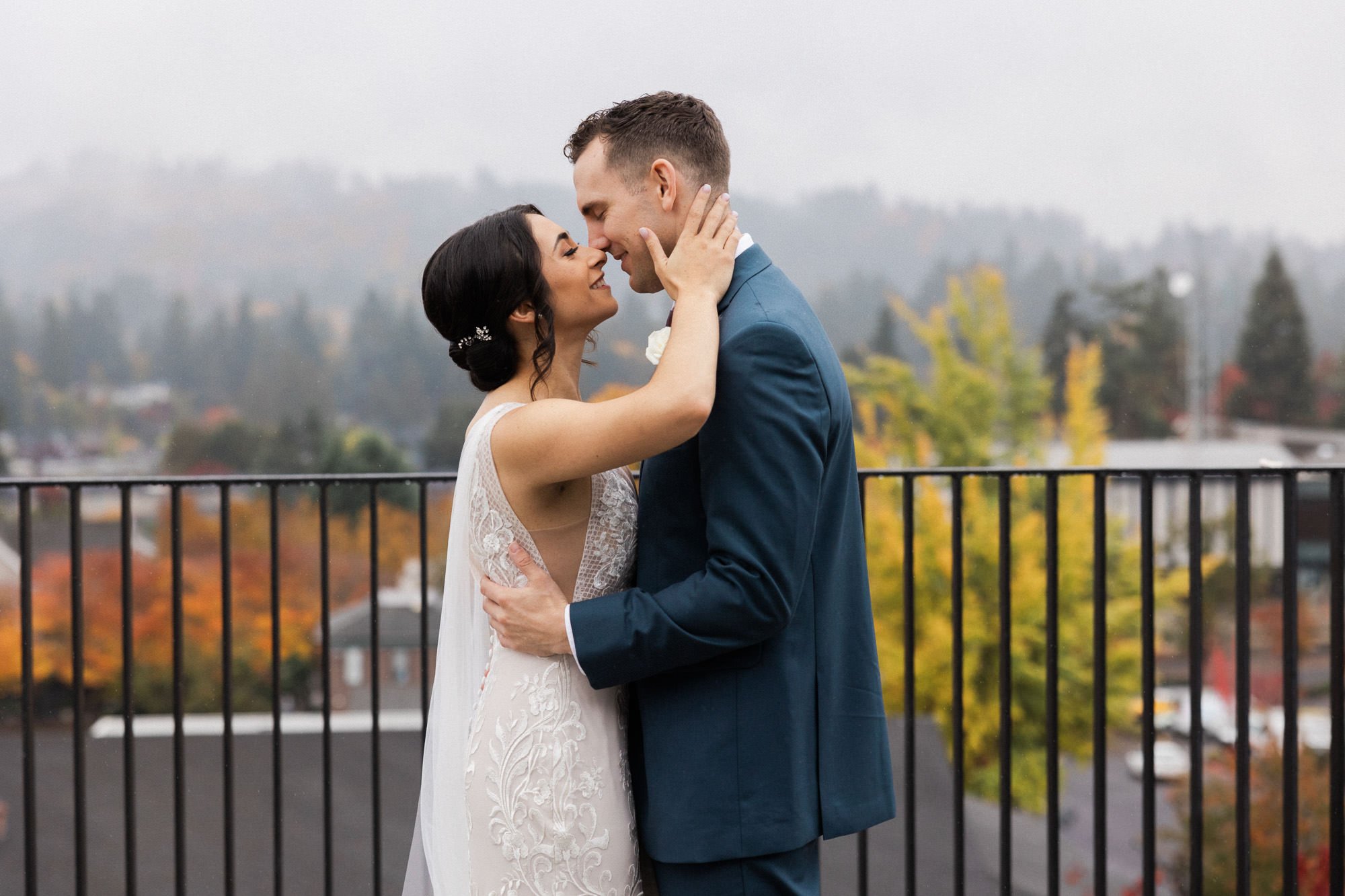 bride and groom embrace each other on balcony at ironlight wedding venue in lake oswego, oregon