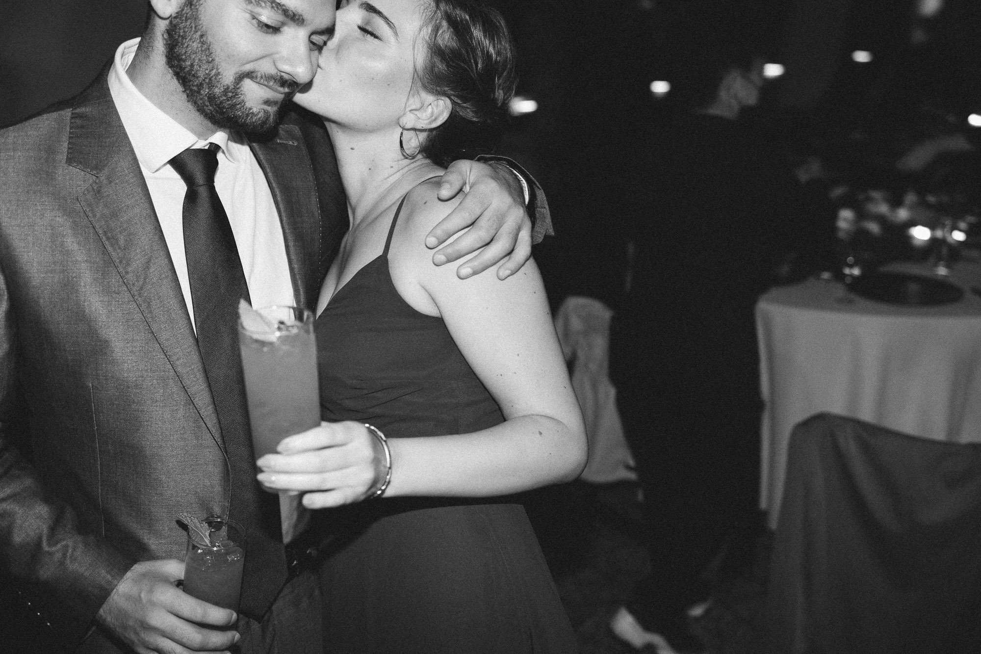 woman kisses man on cheek during wedding reception at ironlight wedding venue in lake oswego, oregon