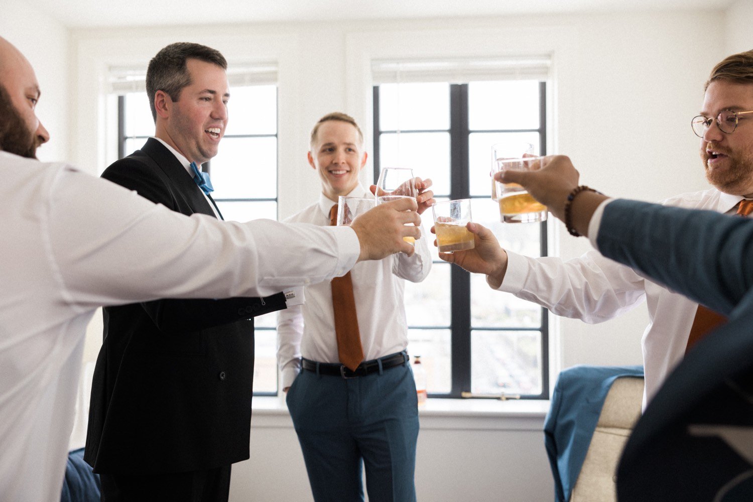 ruins at the astor astoria wedding-21_groom and four groomsmen toast with glasses of whiskey.jpg
