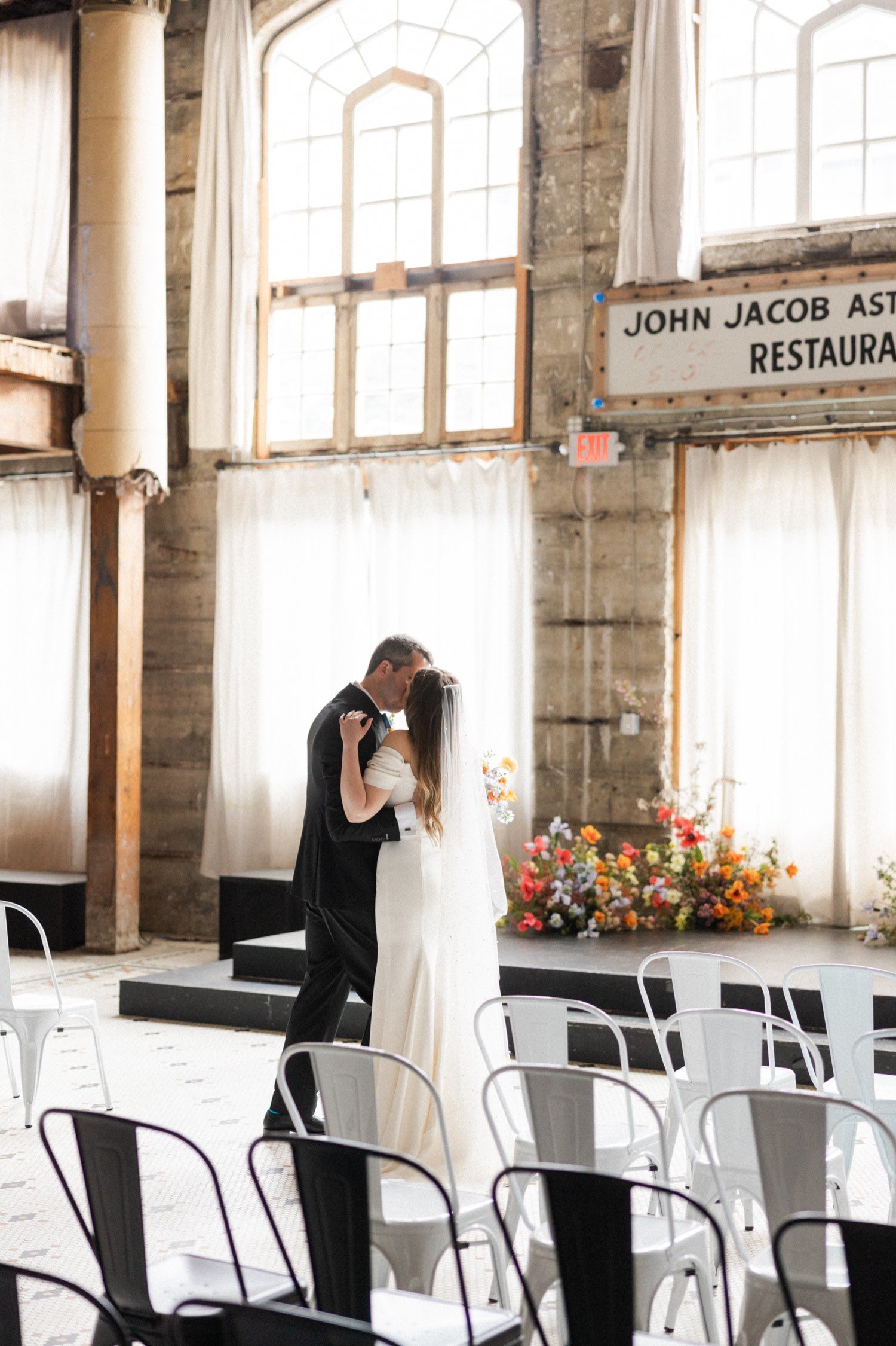 ruins at the astor astoria wedding-38_bride and groom kiss at ceremony location.jpg