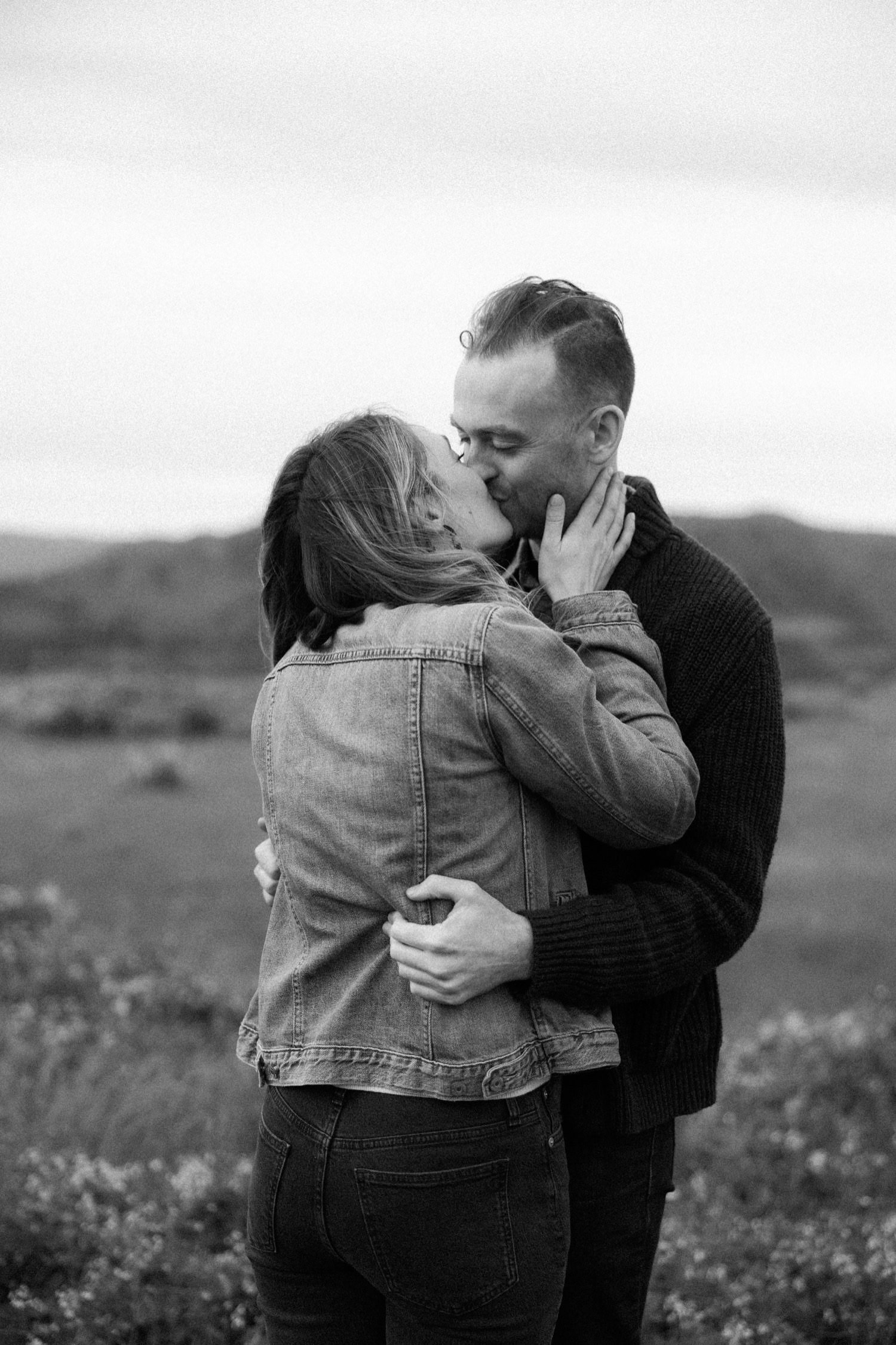 23_Wildflower Engagement Session at Rowena Crest96_black and white photo of man and woman kissing during engagement session at rowena crest.jpg