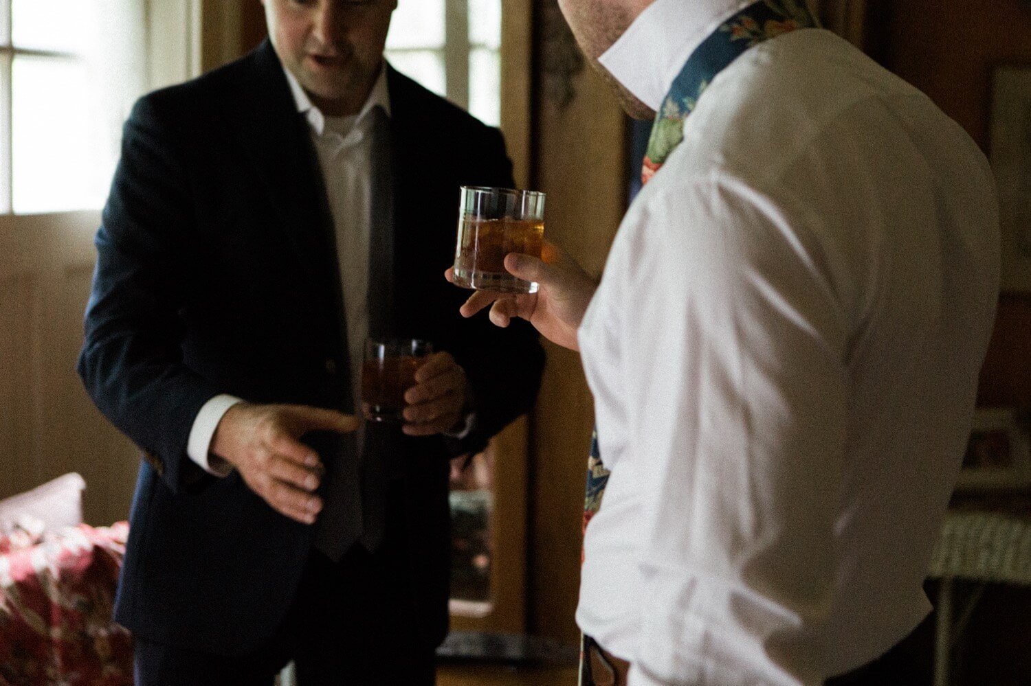 016_Mount Hood Organic Farms Wedding-9092_Two men’s hands holding glasses of whiskey.jpg