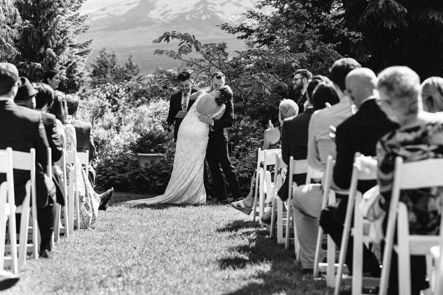 064_Mount Hood Organic Farms Wedding-Black and white photo of bride and groom kissing after ceremony.jpg