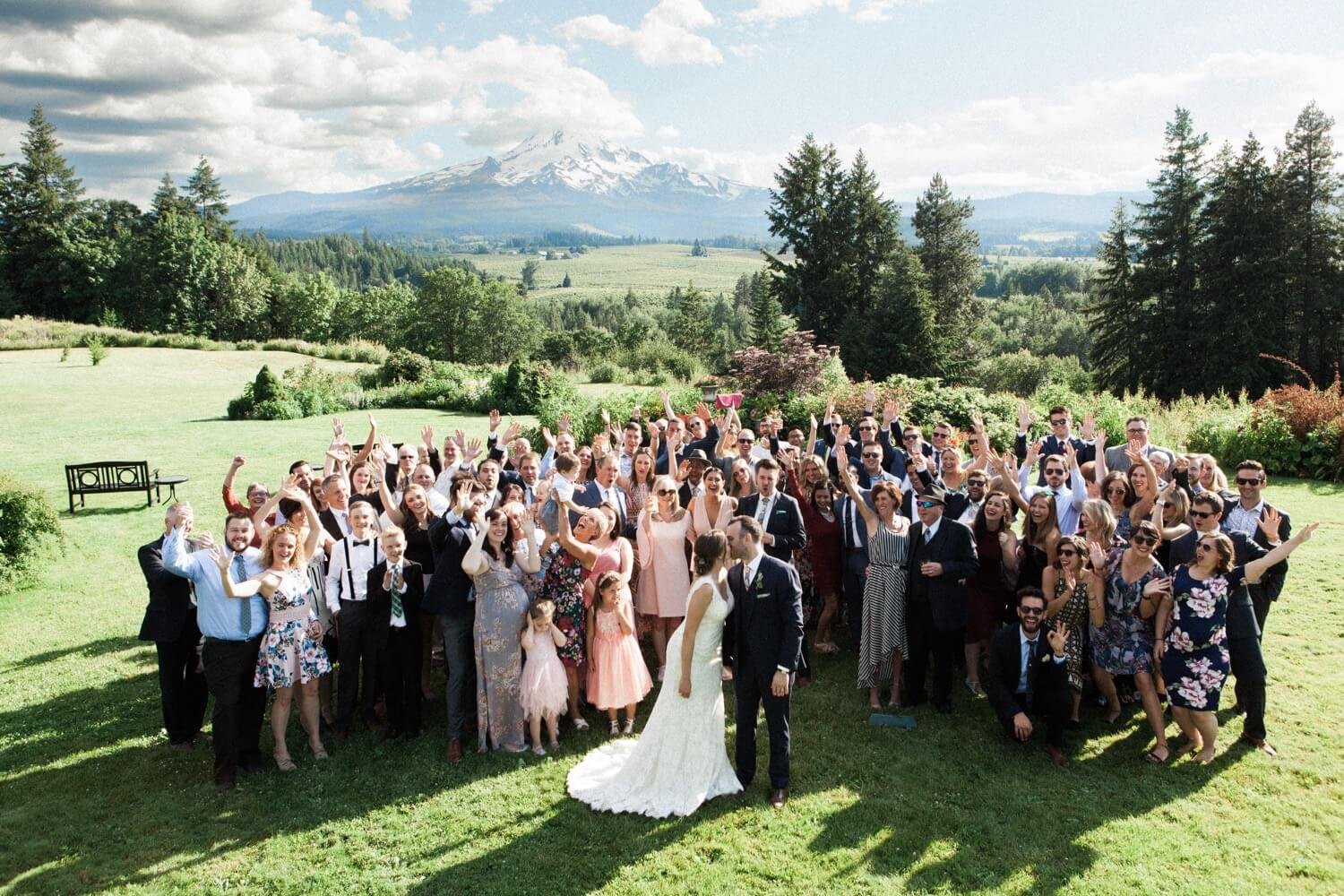 067_Mount Hood Organic Farms Wedding-Bride and groom kiss in front of cheering guests at mount hood wedding.jpg