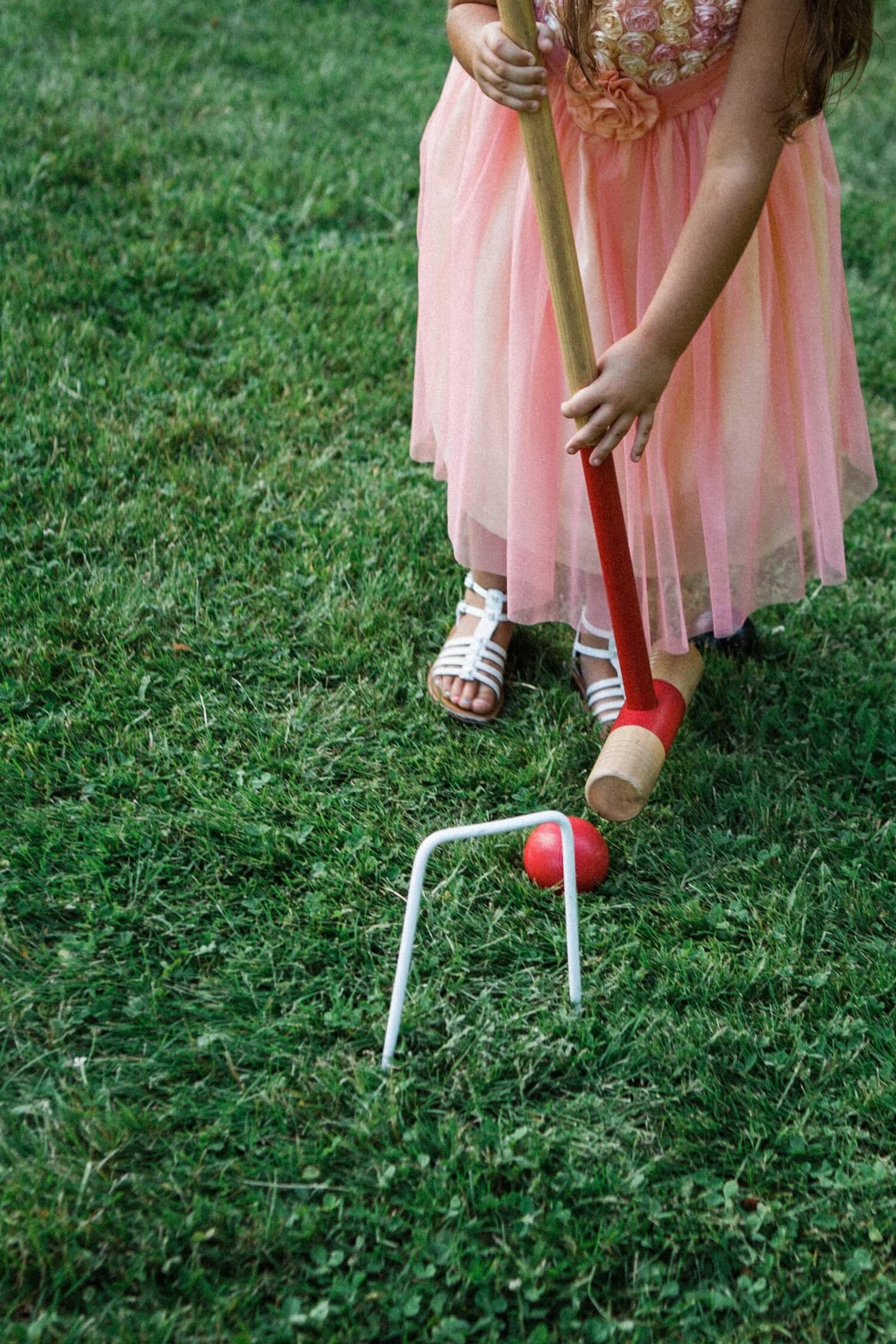 068_Mount Hood Organic Farms Wedding-Girl’s hands hold croquet mallet.jpg