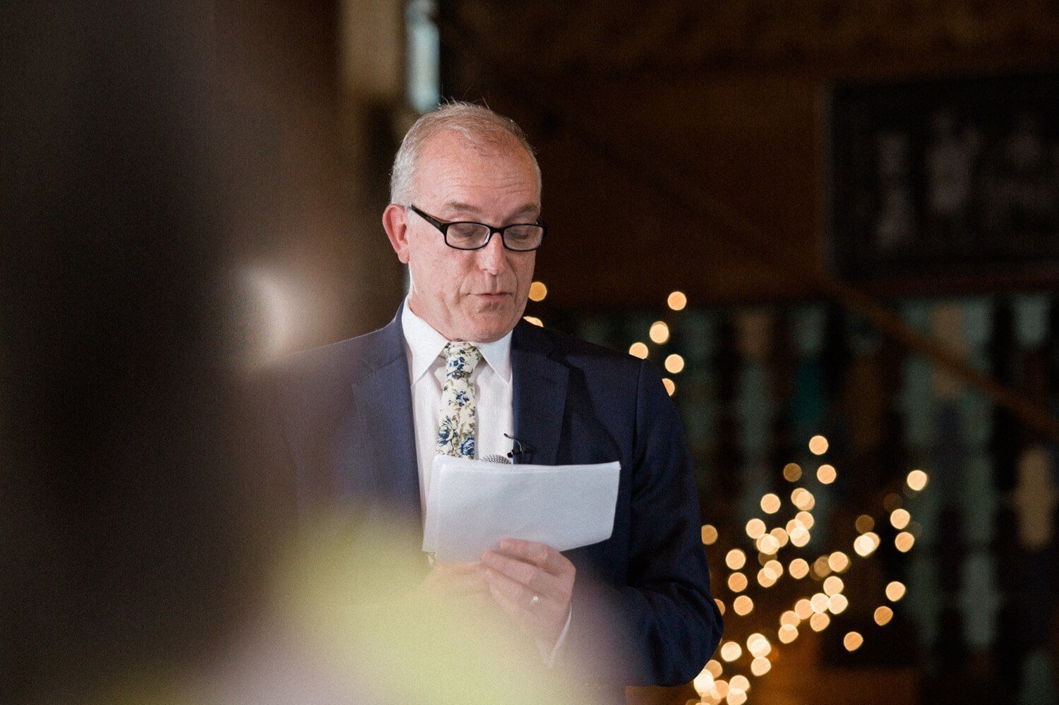 081_Mount Hood Organic Farms Wedding-Man in white shirt and blue jacket reads from paper.jpg