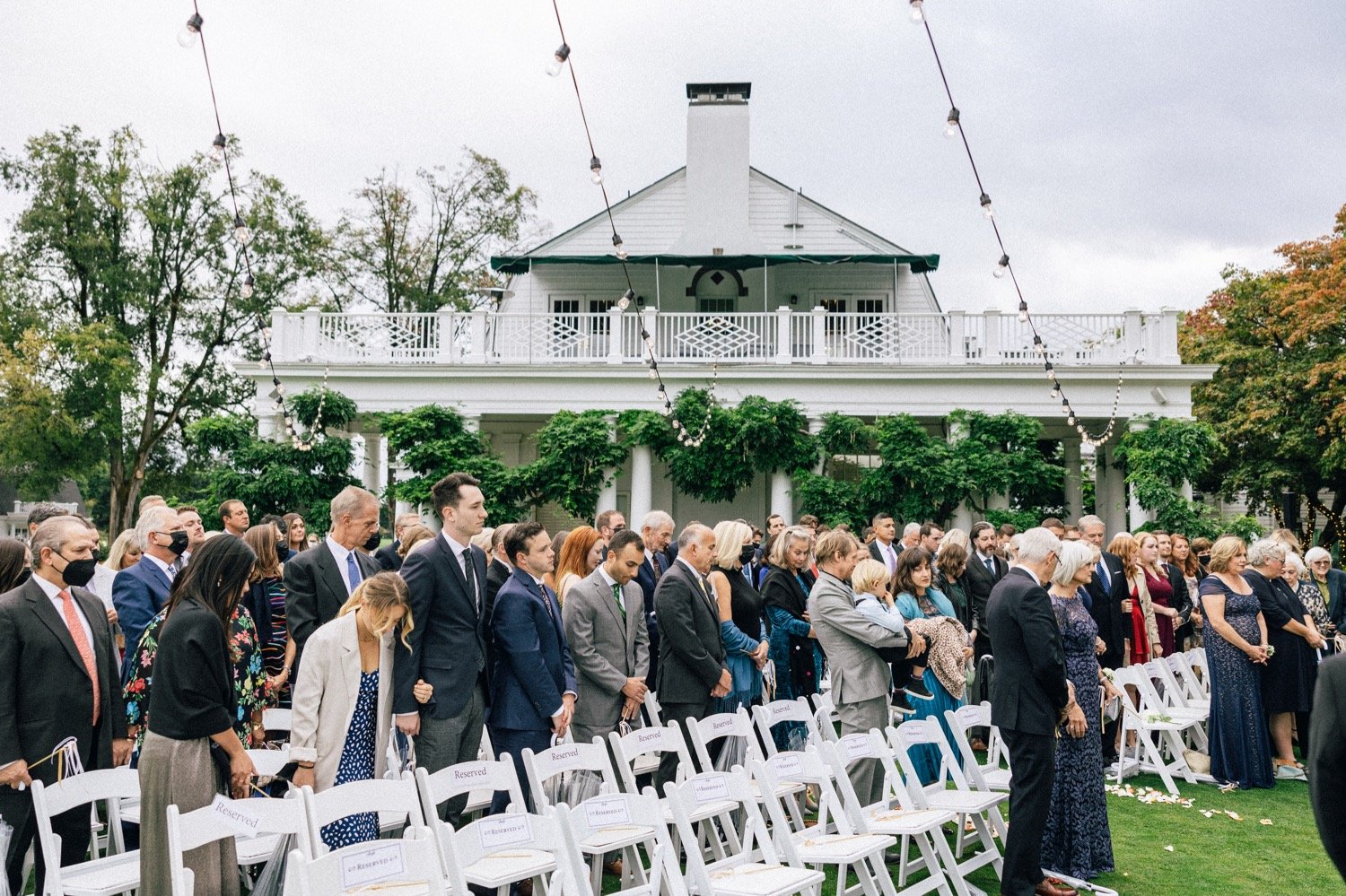  Guests stand during wedding ceremony at Waverley Country Club in Portland, Oregon 
