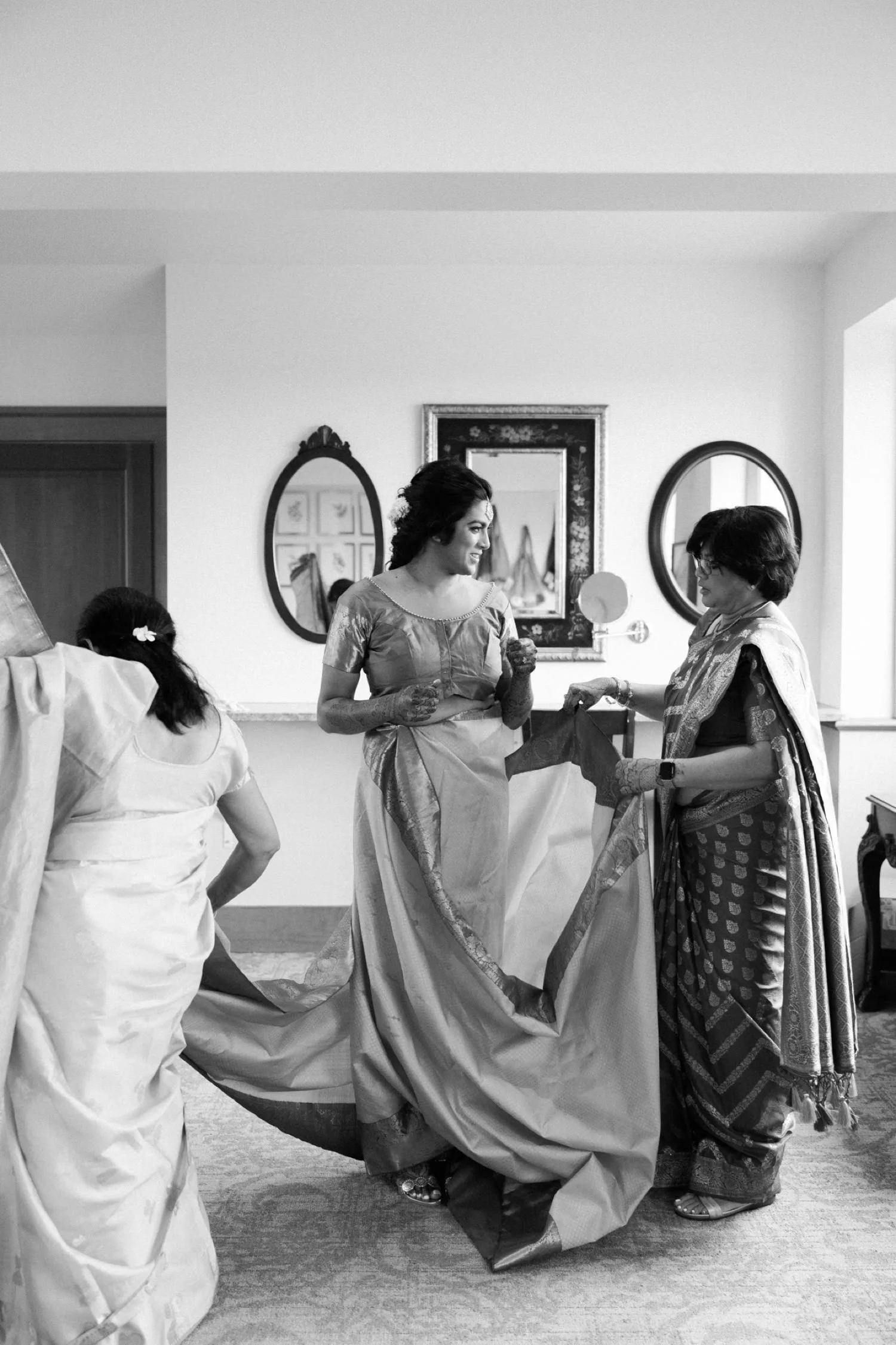 008_Oregon Golf Club Indian Wedding-46_two women wrap sari around bride.jpg