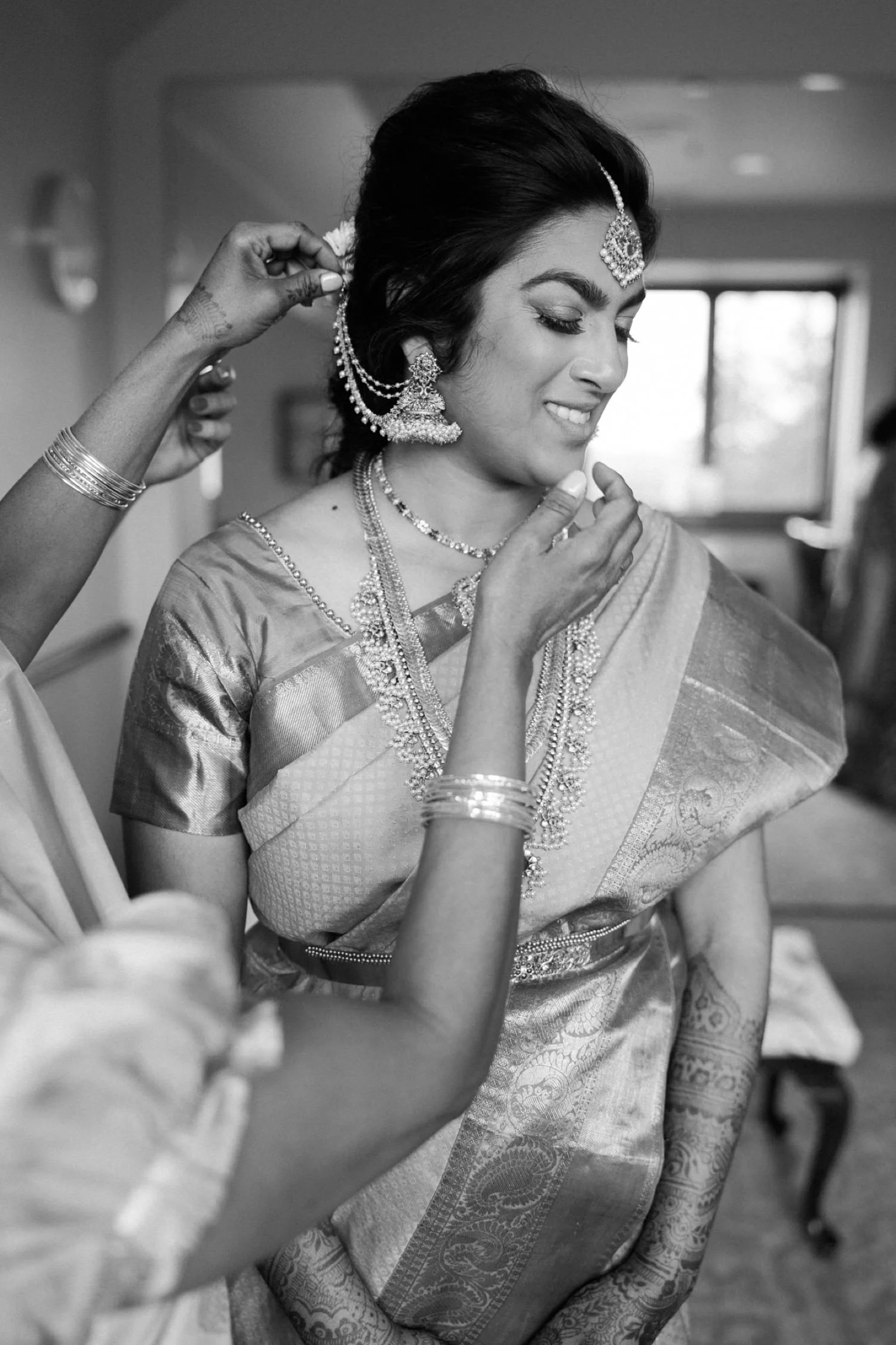 026_Oregon Golf Club Indian Wedding-70_woman puts earring on bride.jpg