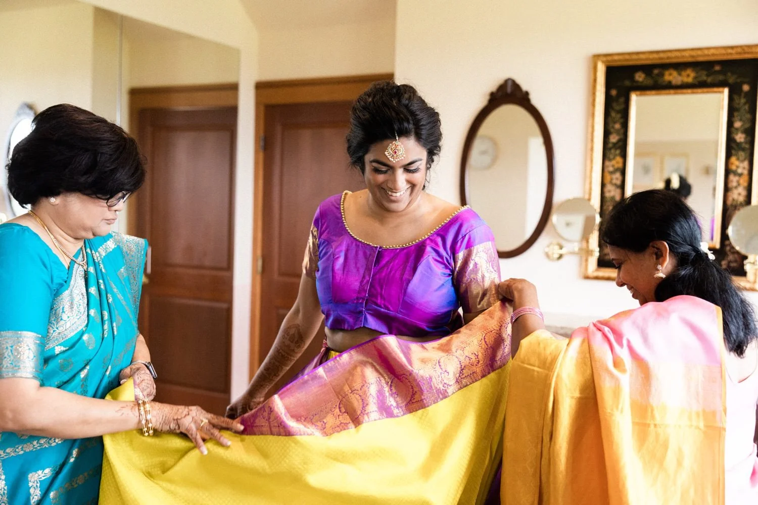 032_Oregon Golf Club Indian Wedding-45_two women tie yellow and purple sari around bride.jpg