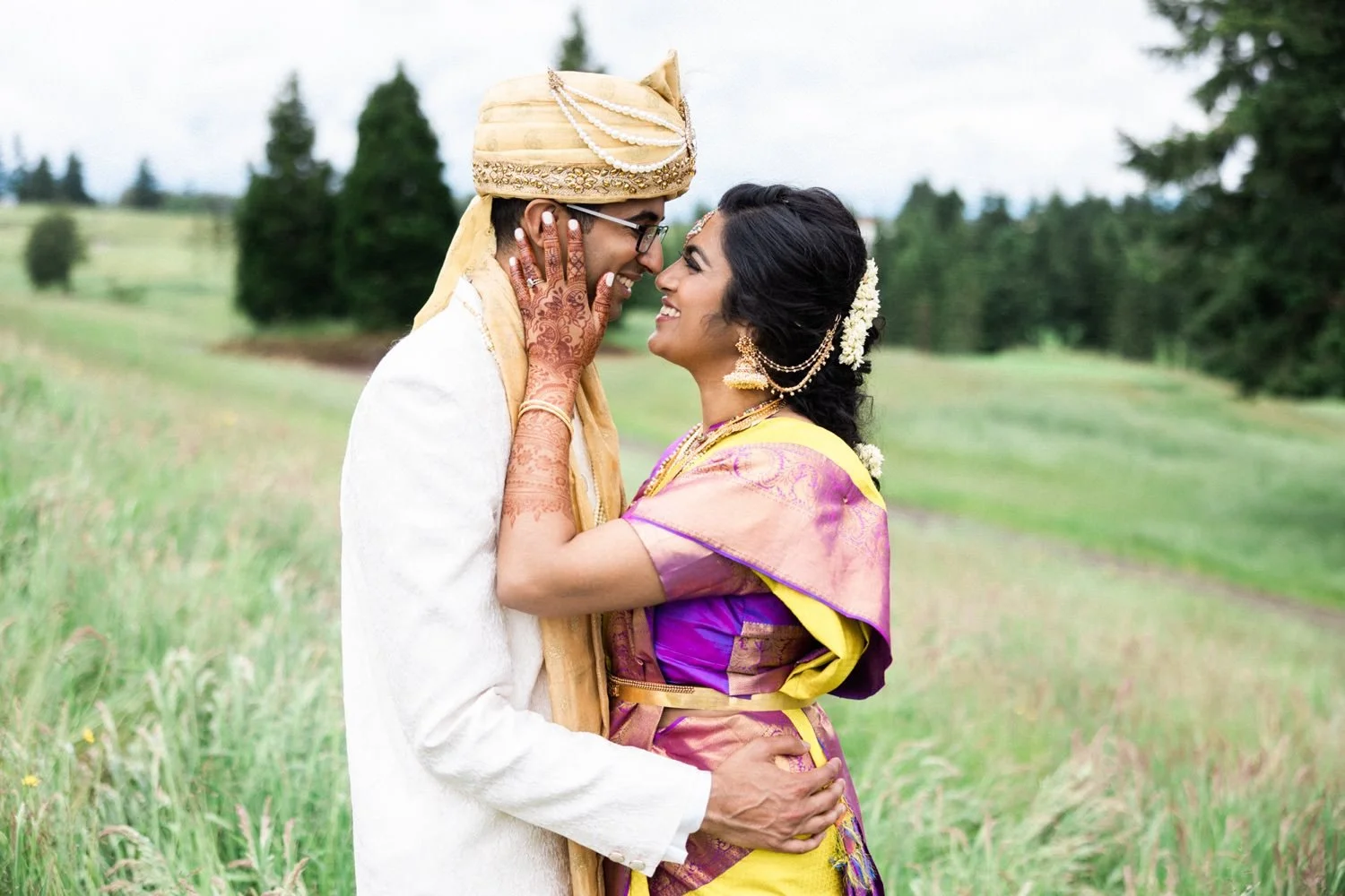 044_Oregon Golf Club Indian Wedding-197_bride in henna and sari holds face of groom in Sherwani and turban.jpg