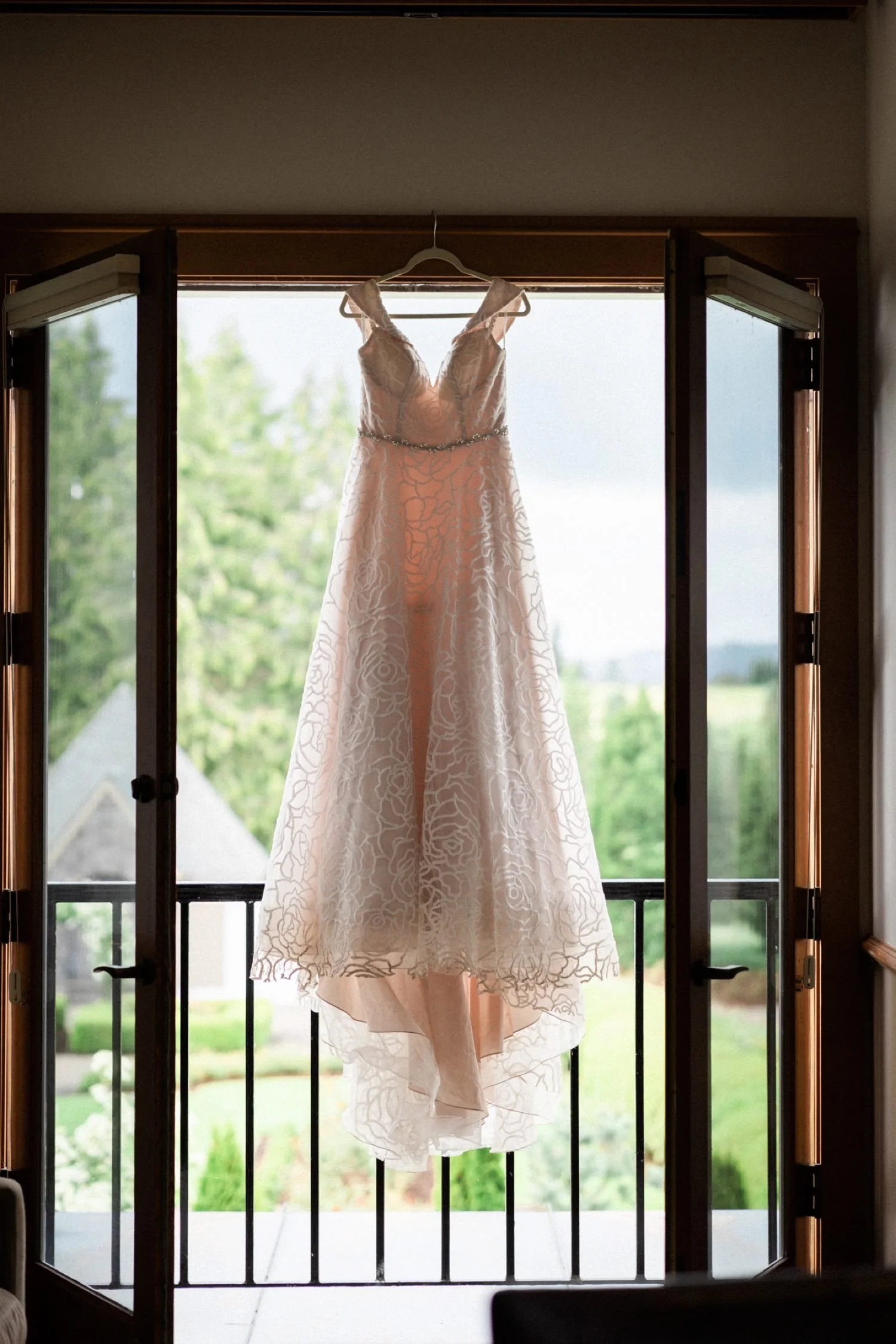 086_Oregon Golf Club Indian Wedding-203_wedding dress hanging from window.jpg